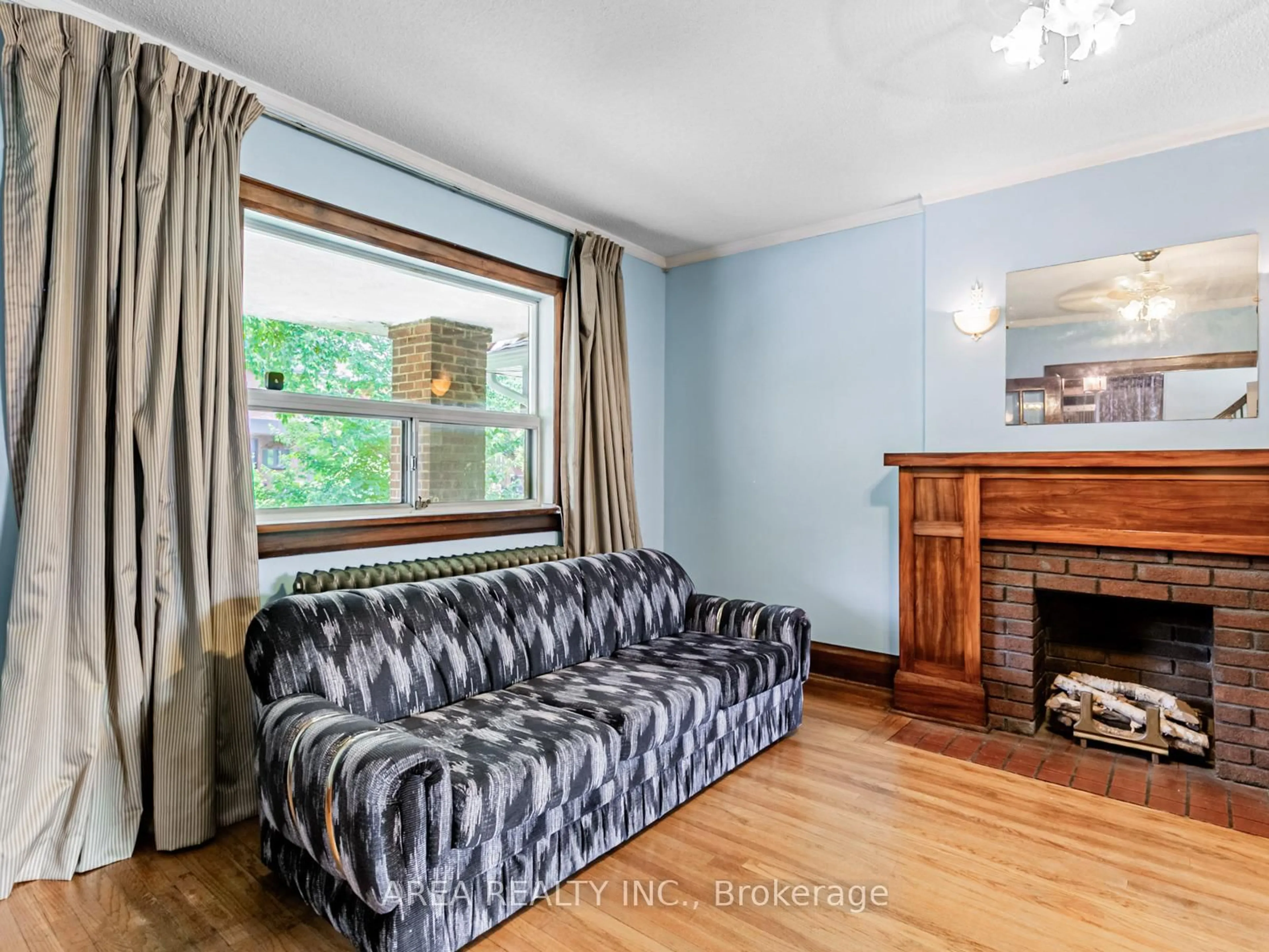 Living room with furniture, wood/laminate floor for 65 St Annes Rd, Toronto Ontario M6J 2C4