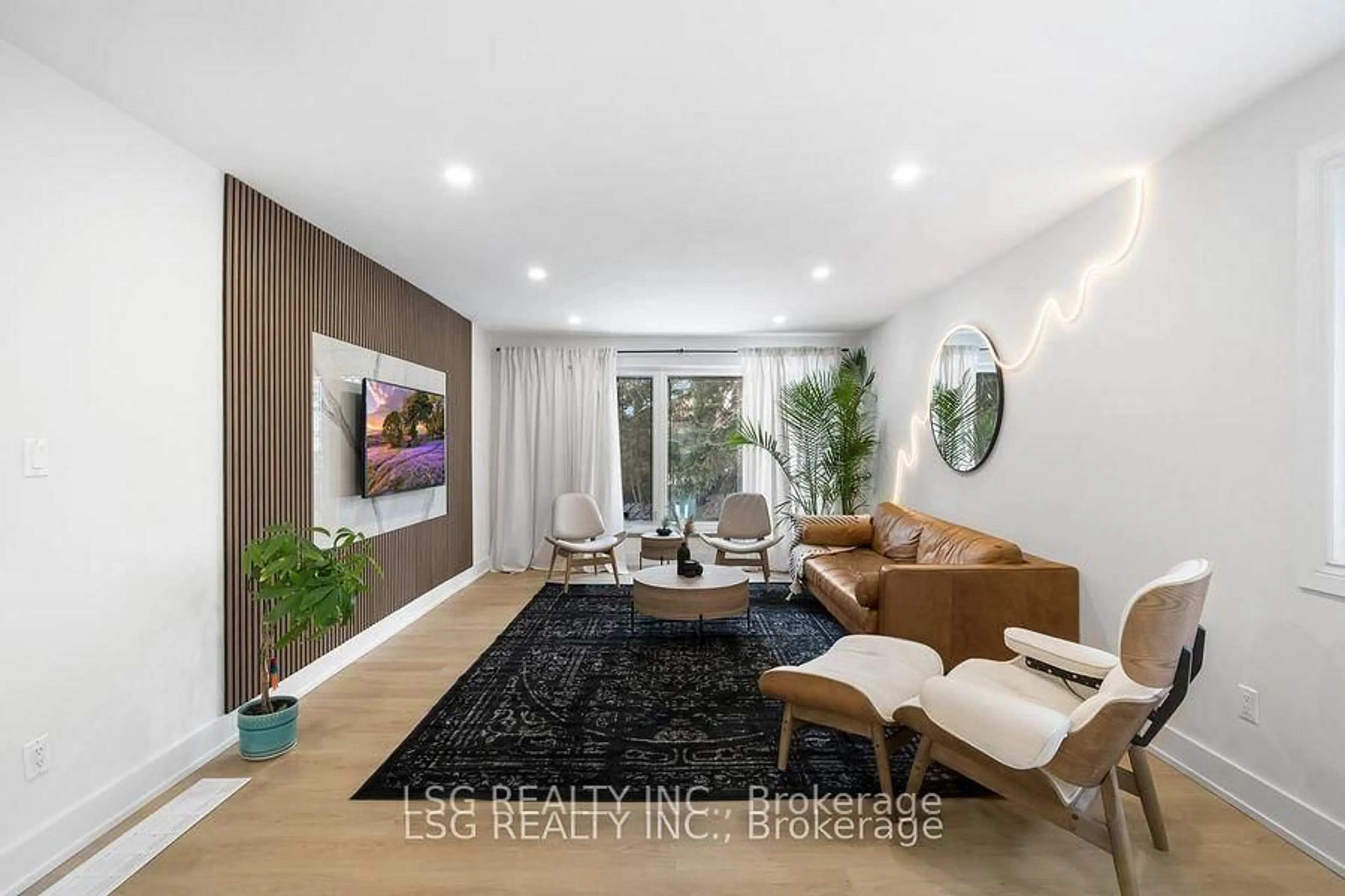 Living room with furniture, wood/laminate floor for 26 Grangemill Cres, Toronto Ontario M3B 2J2