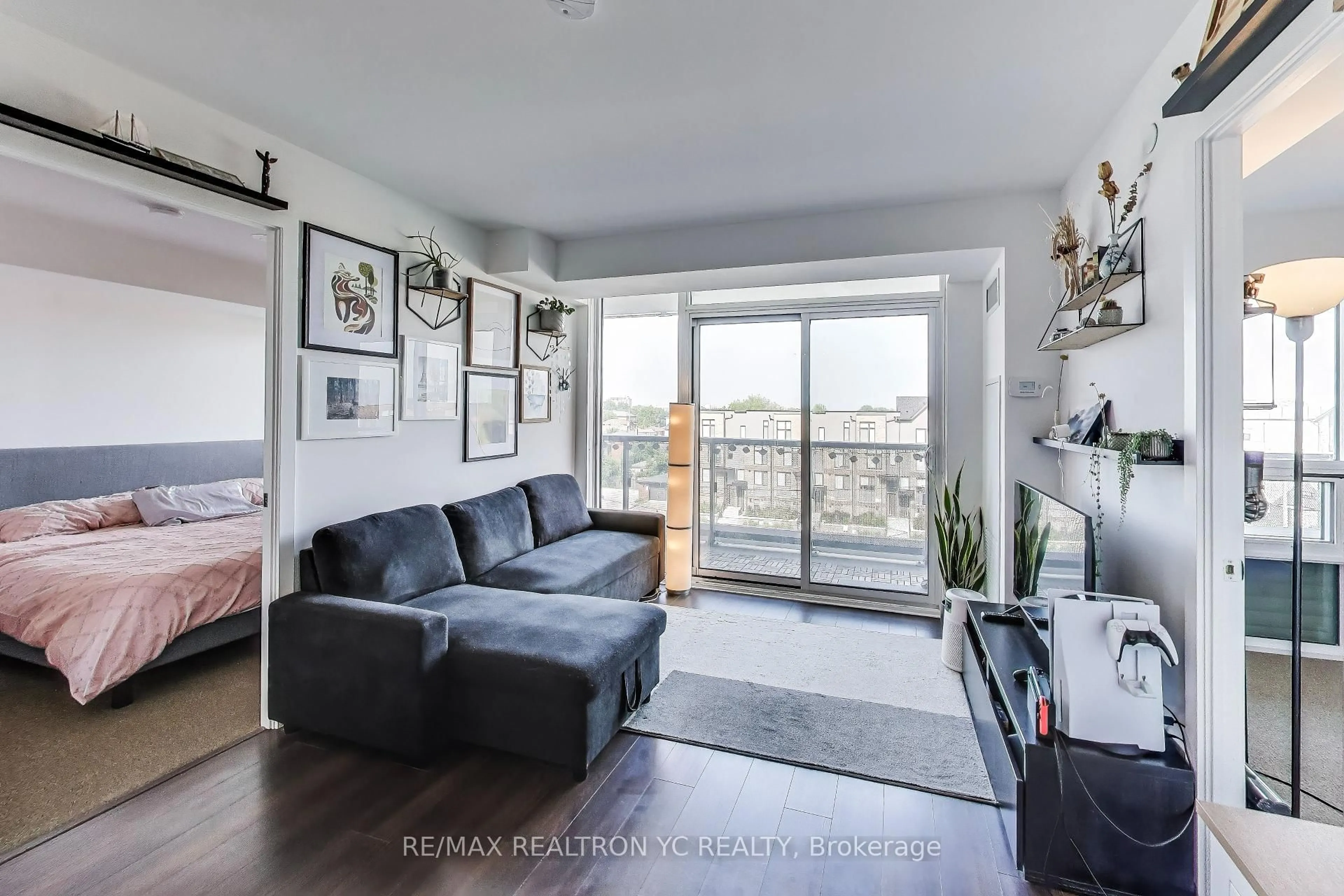 Living room with furniture, wood/laminate floor for 120 Varna Dr #520, Toronto Ontario M6A 0B3
