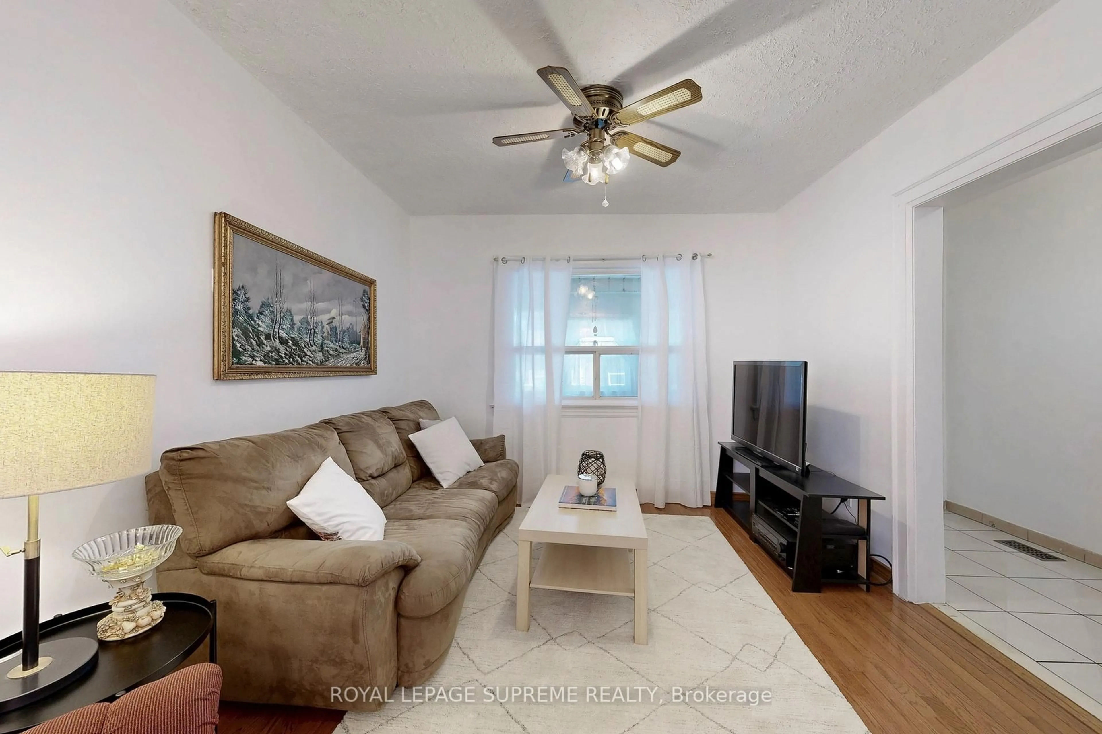 Living room with furniture, wood/laminate floor for 354 Winona Dr, Toronto Ontario M6C 3T3