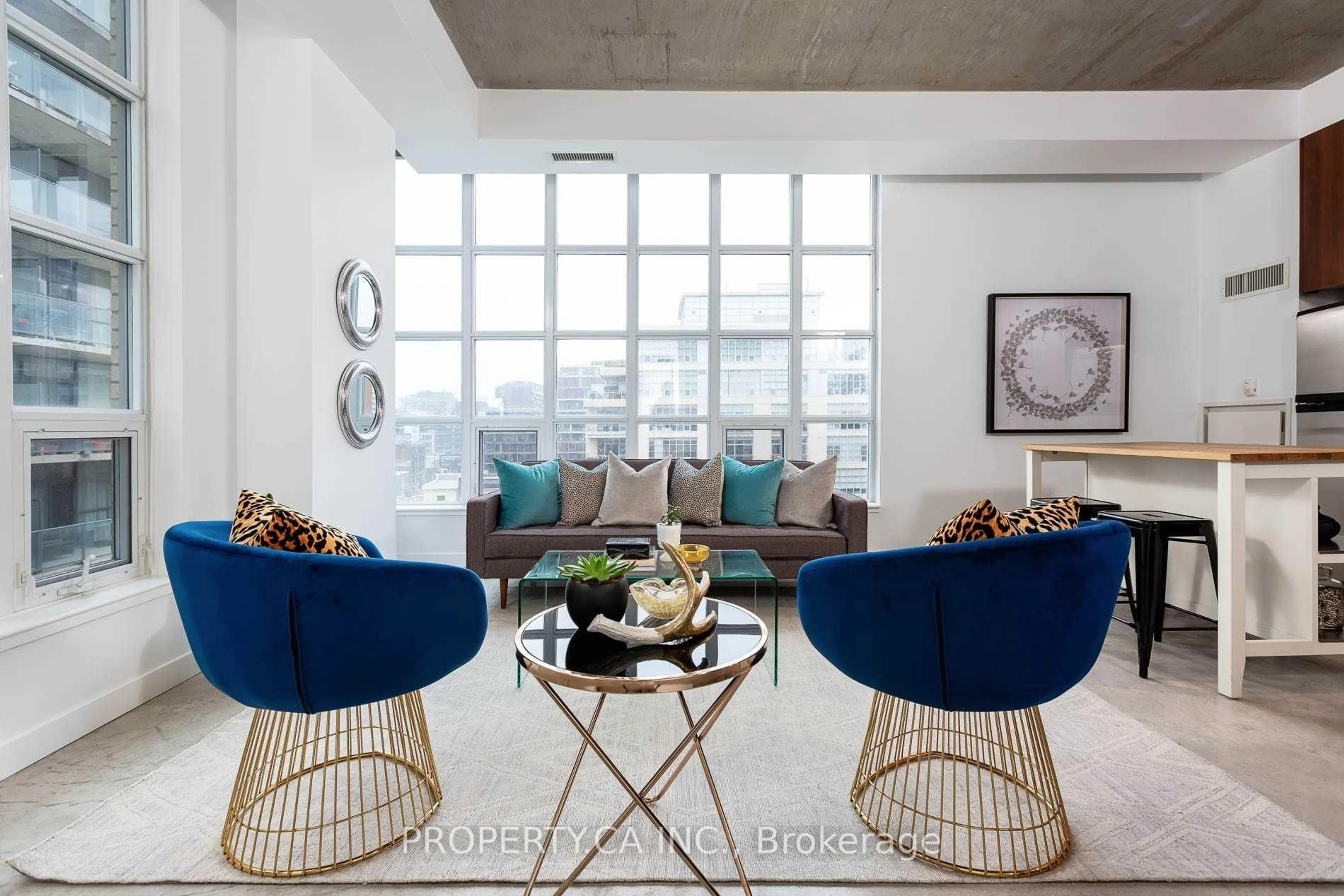 Living room with furniture, cement floor for 23 Brant St #705, Toronto Ontario M5V 2L5