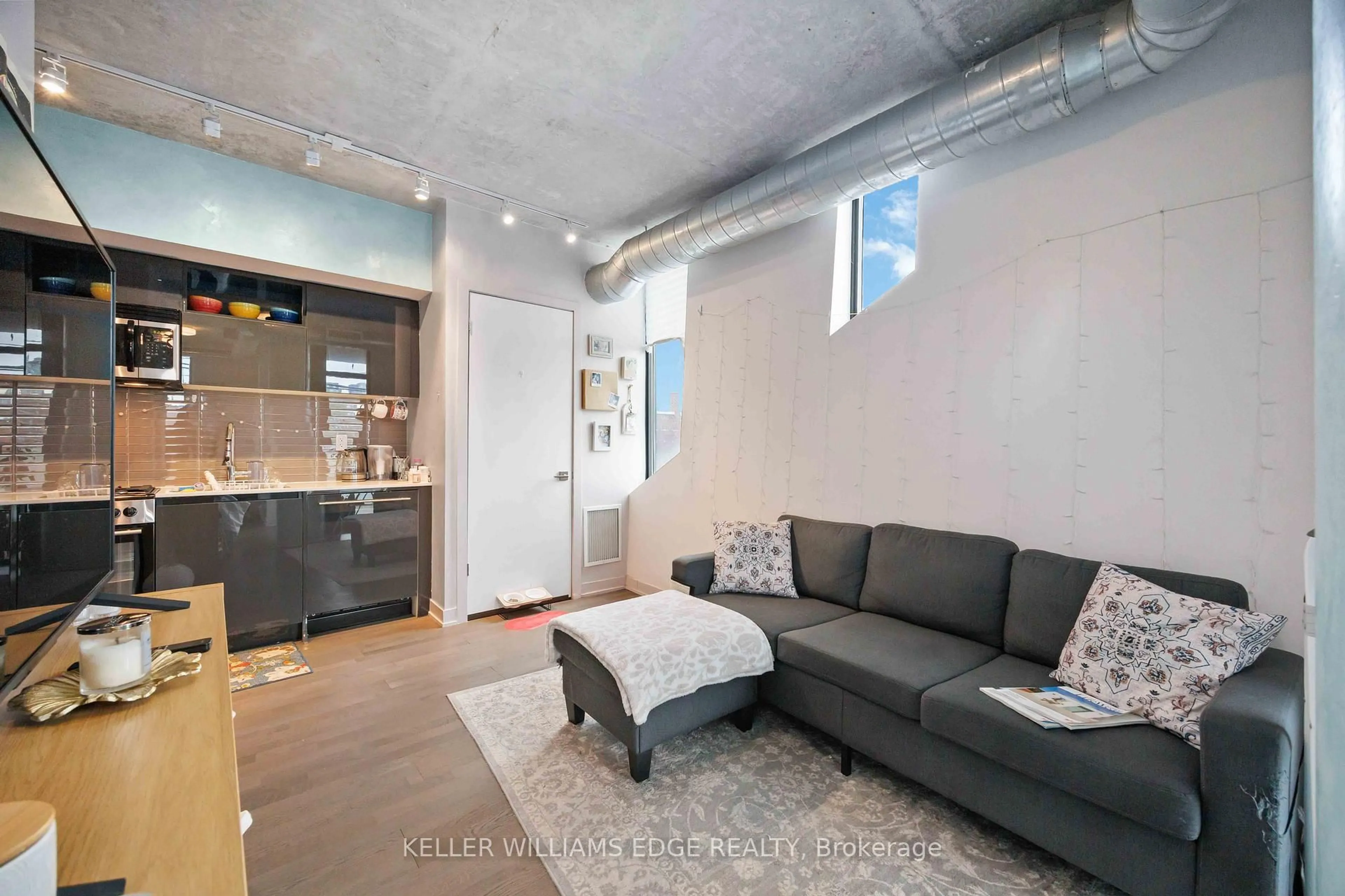 Living room with furniture, cement floor for 109 Wolseley St #204, Toronto Ontario M6J 1K1