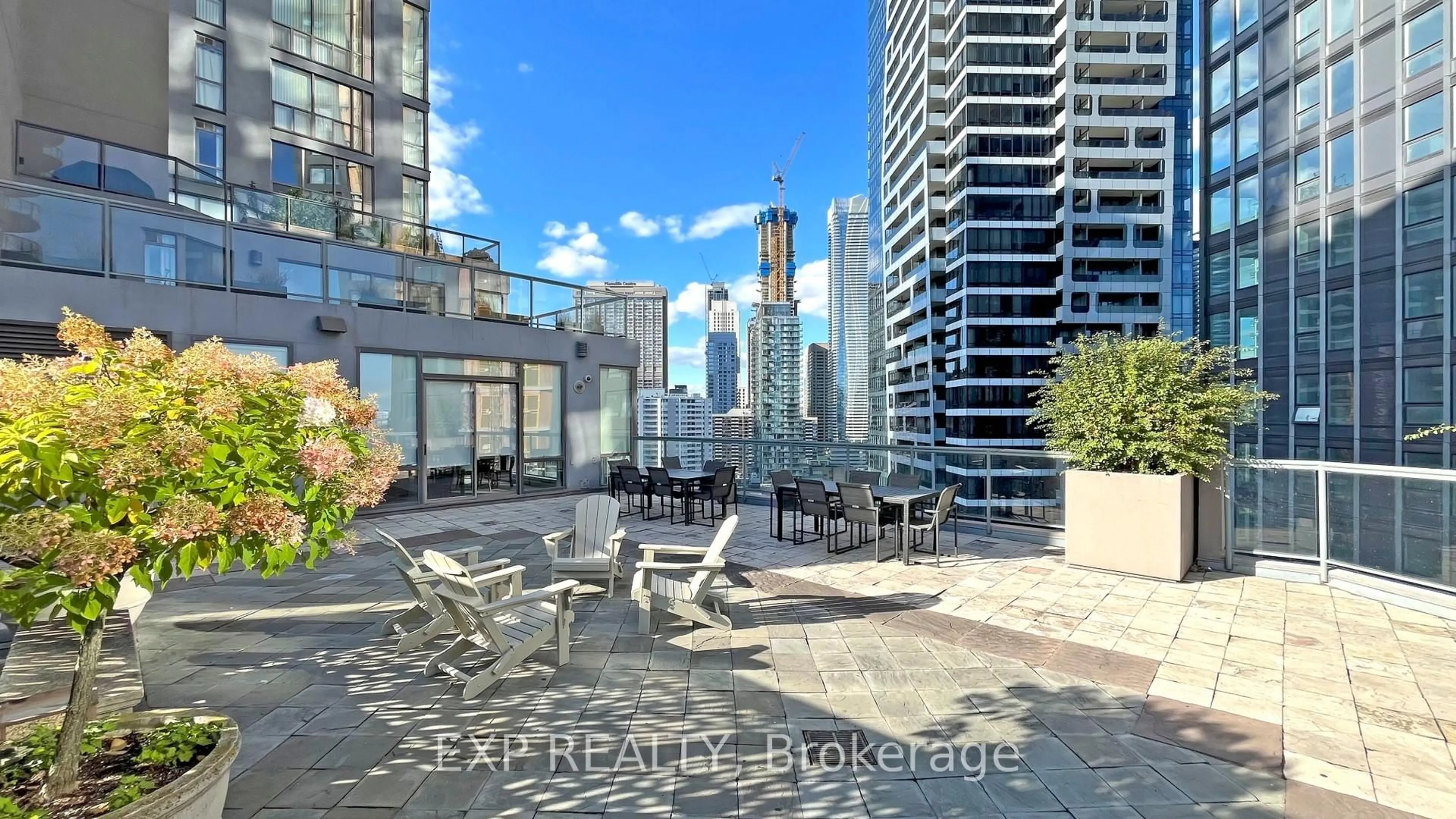 Patio, city buildings view from balcony for 24 Wellesley St #1105, Toronto Ontario M4Y 2X6
