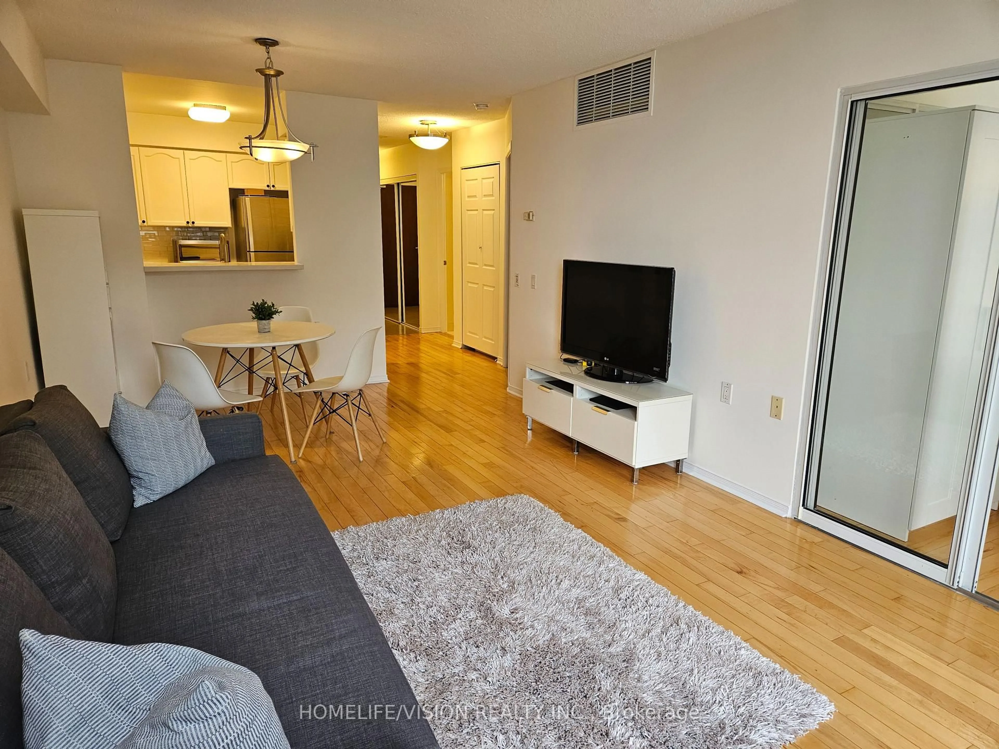 Living room with furniture, wood/laminate floor for 35 Finch Ave #703, Toronto Ontario M2N 6Z8