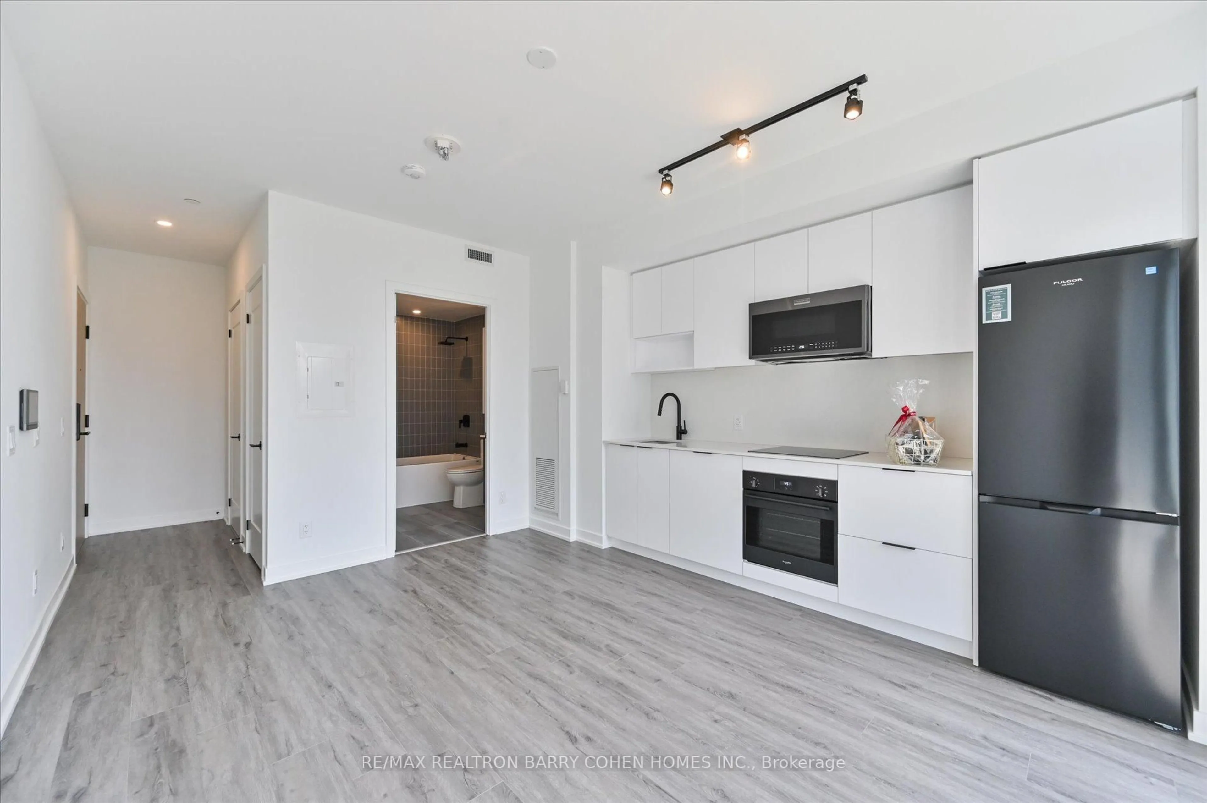Open concept kitchen, wood/laminate floor for 5 Defries St #1118, Toronto Ontario M5A 0W7