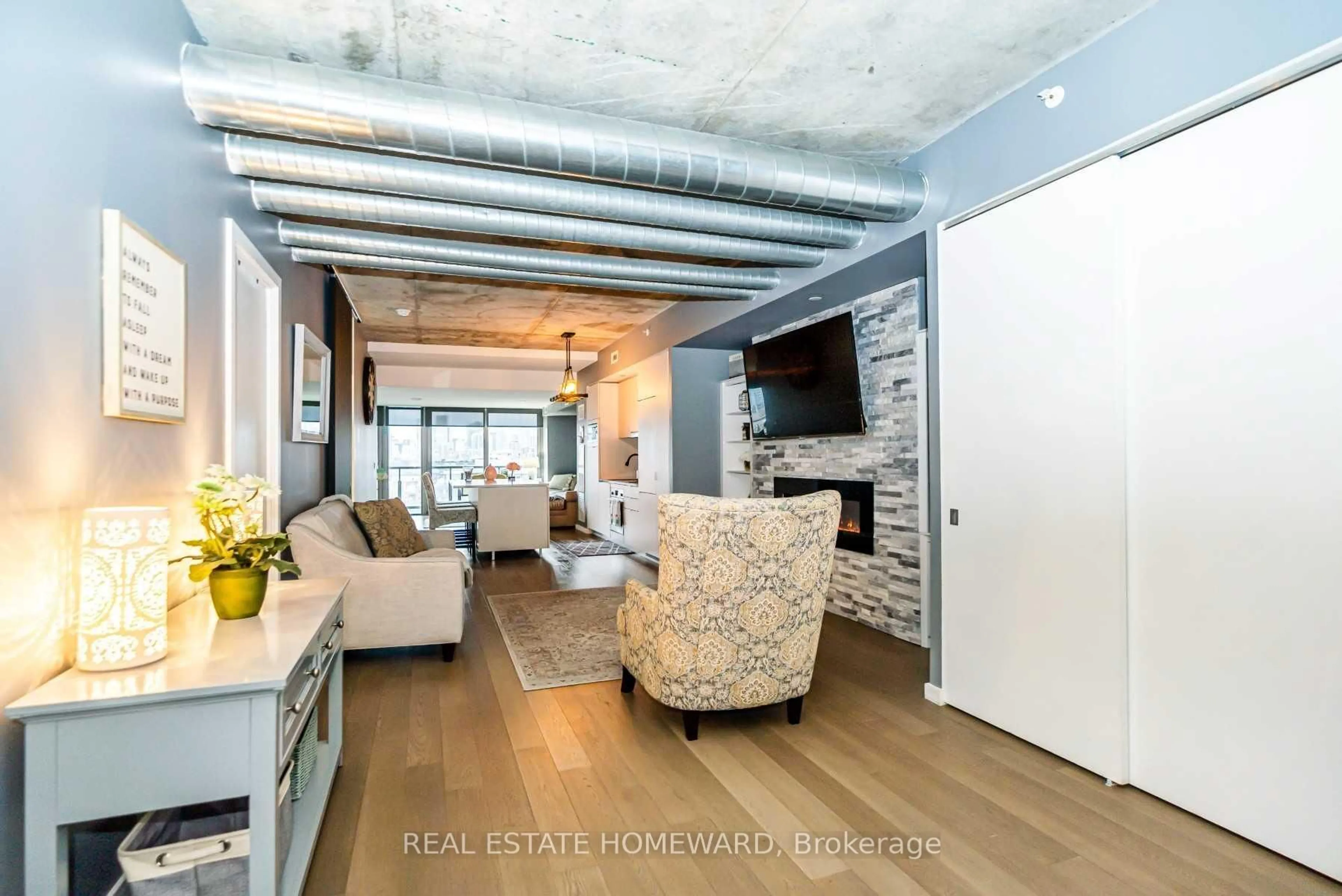 Living room with furniture, cement floor for 170 Bayview Ave #1104, Toronto Ontario M5A 0M4