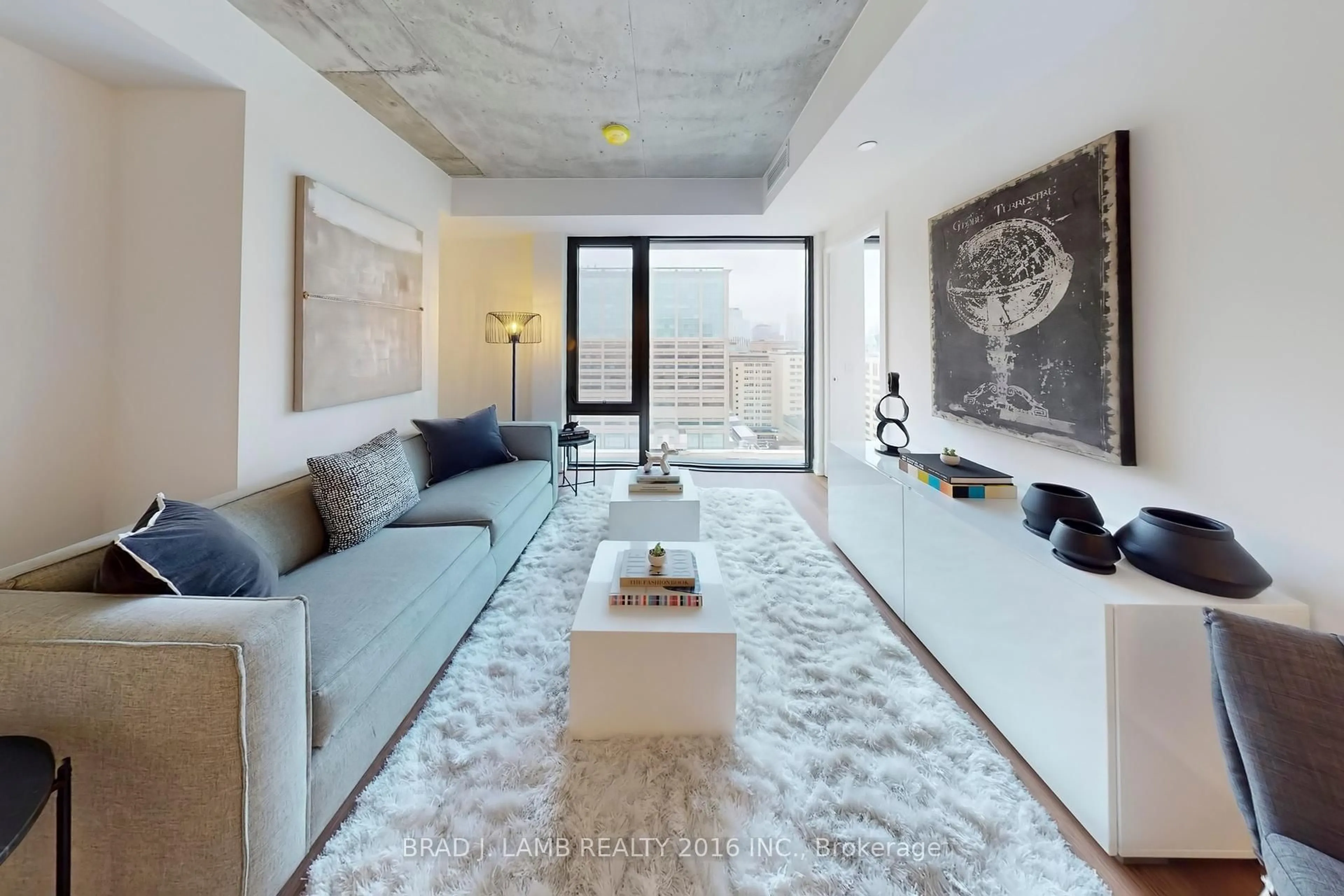 Living room with furniture, cement floor for 195 McCaul St #1203, Toronto Ontario M5T 0E5
