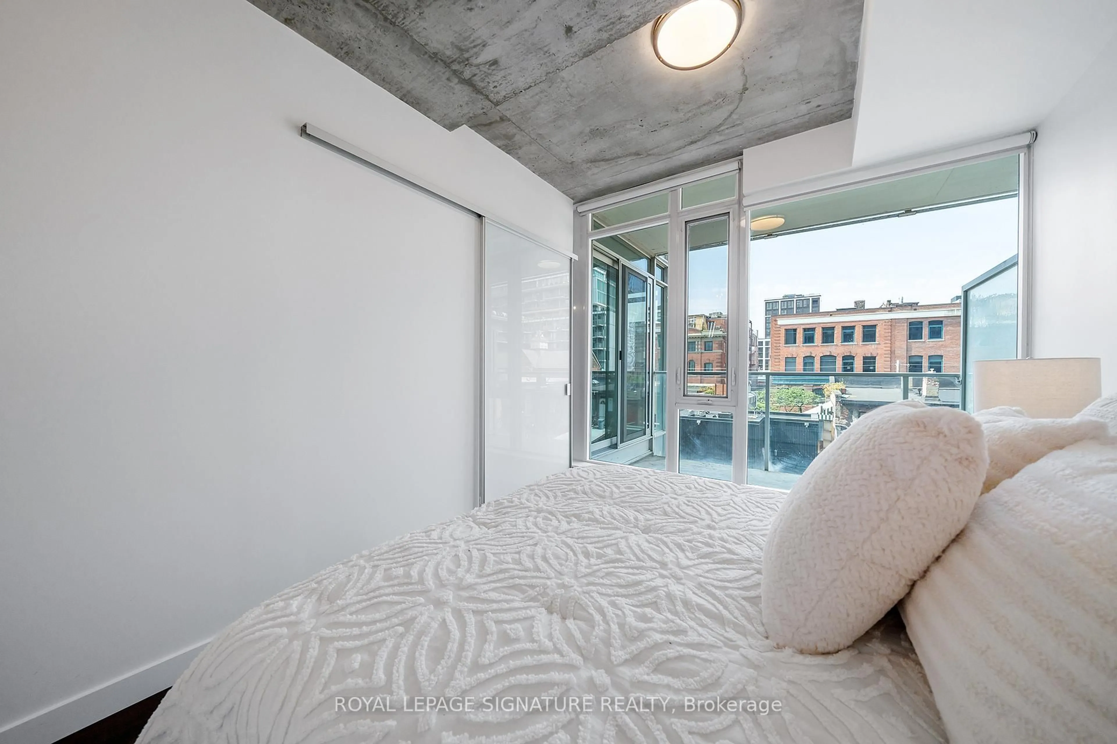 Bedroom with bed, cement floor for 75 Portland St #510, Toronto Ontario M5V 2M9