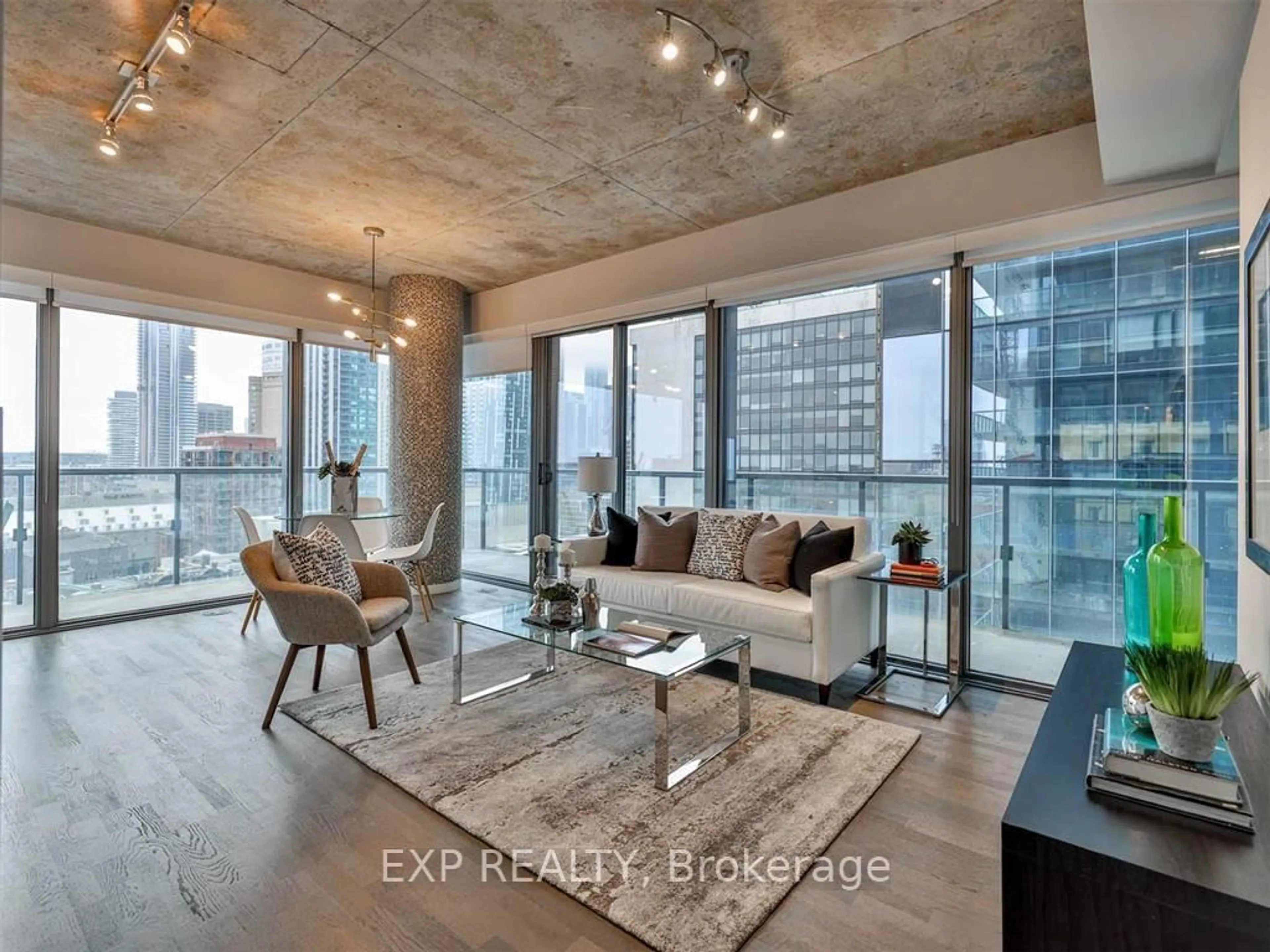Living room with furniture, cement floor for 60 Colborne St #1306, Toronto Ontario M5B 2B7