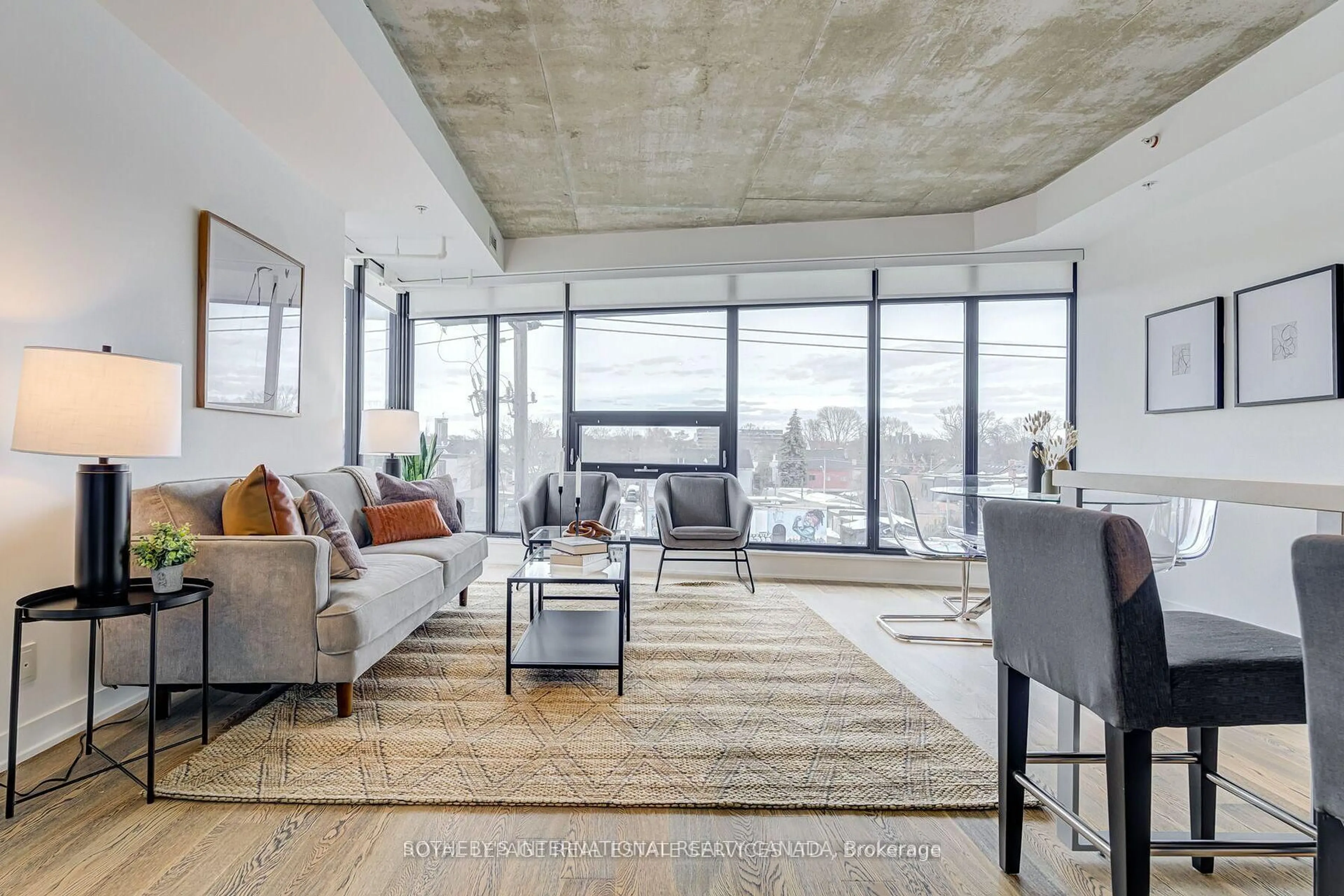 Living room with furniture, cement floor for 1239 Dundas St #404, Toronto Ontario M6J 0E8