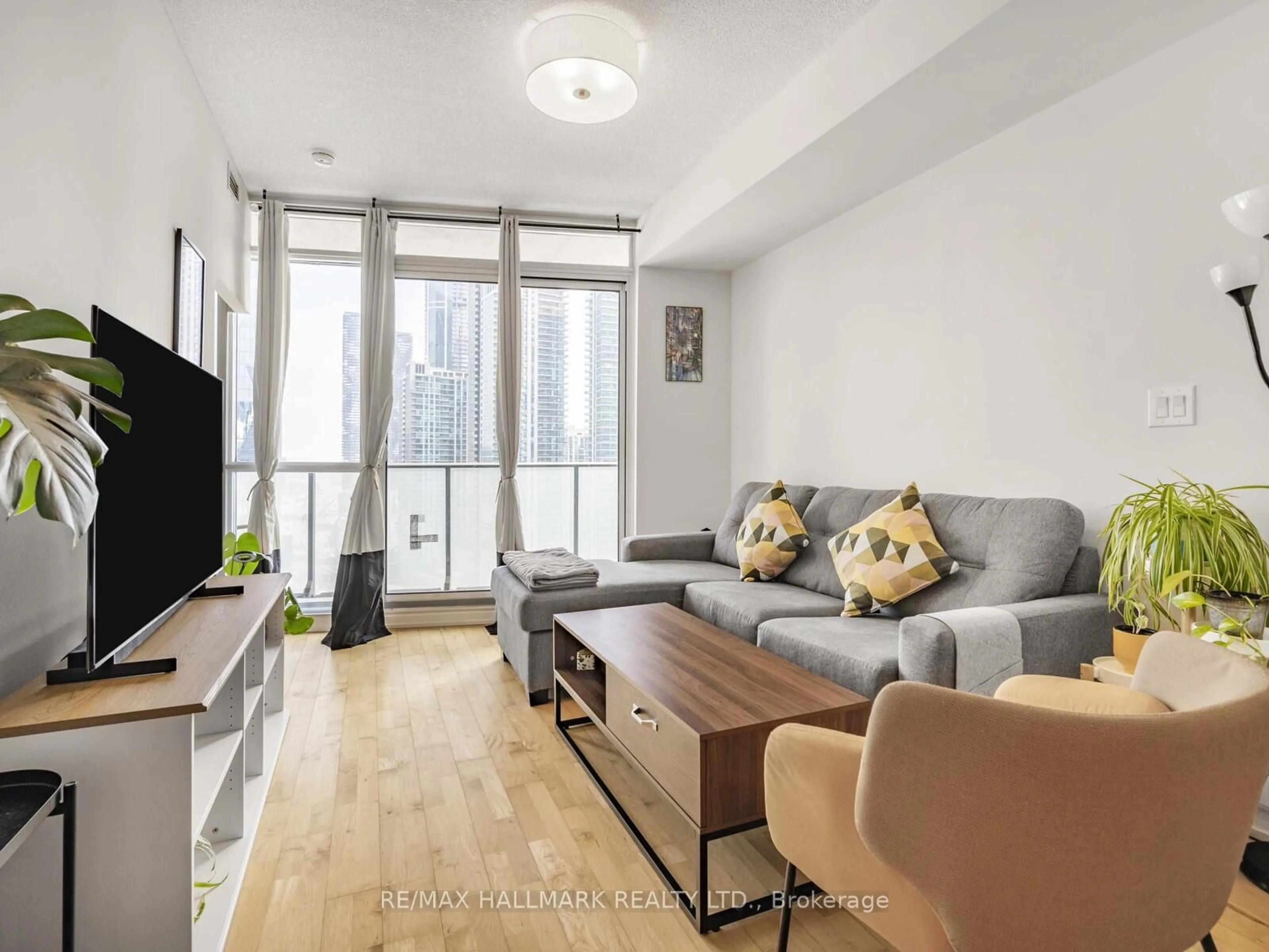 Living room with furniture, wood/laminate floor for 65 Bremner Blvd #2109, Toronto Ontario M5J 0A7