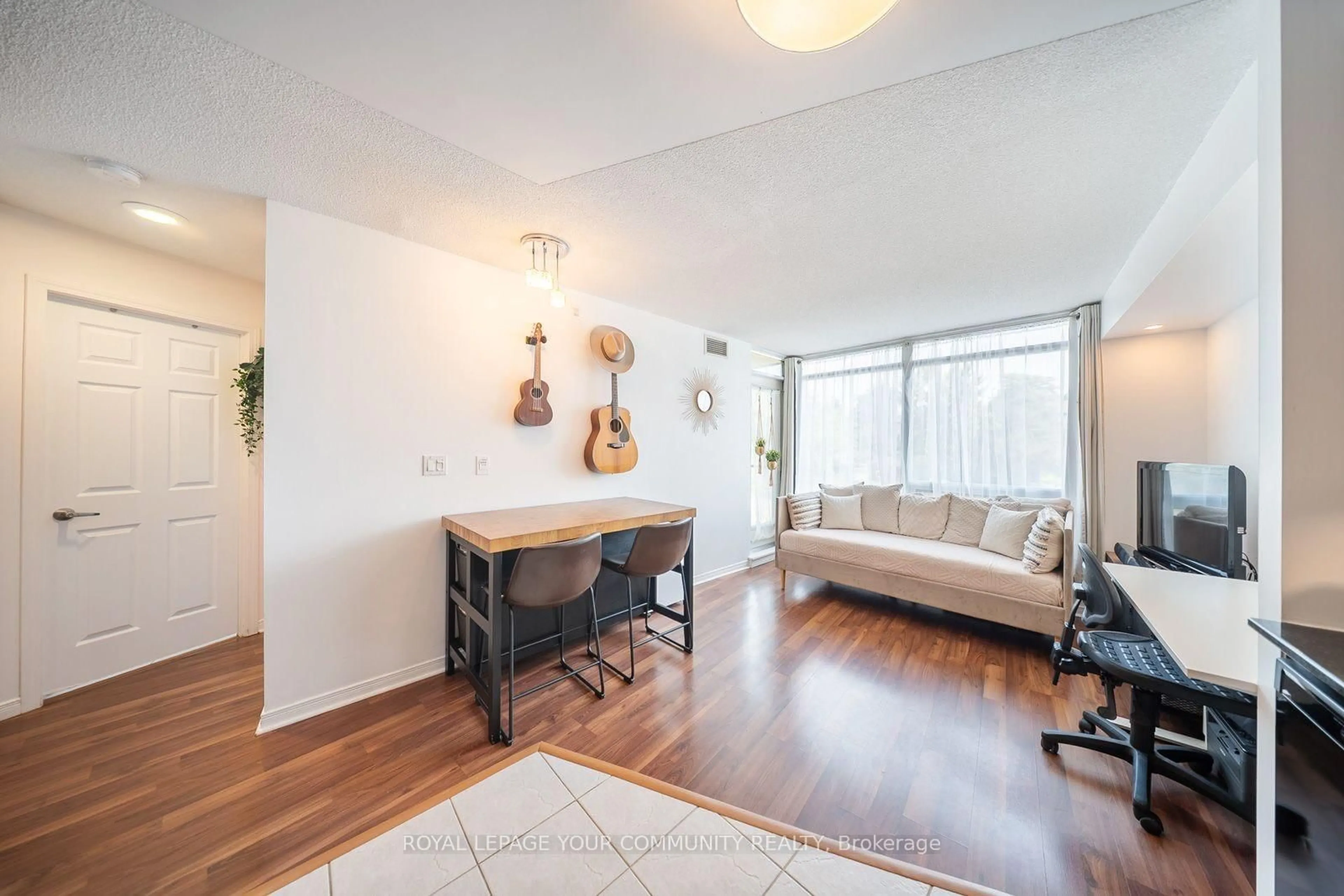 Living room with furniture, wood/laminate floor for 18 Valley Woods Rd #716, Toronto Ontario M3A 0A1