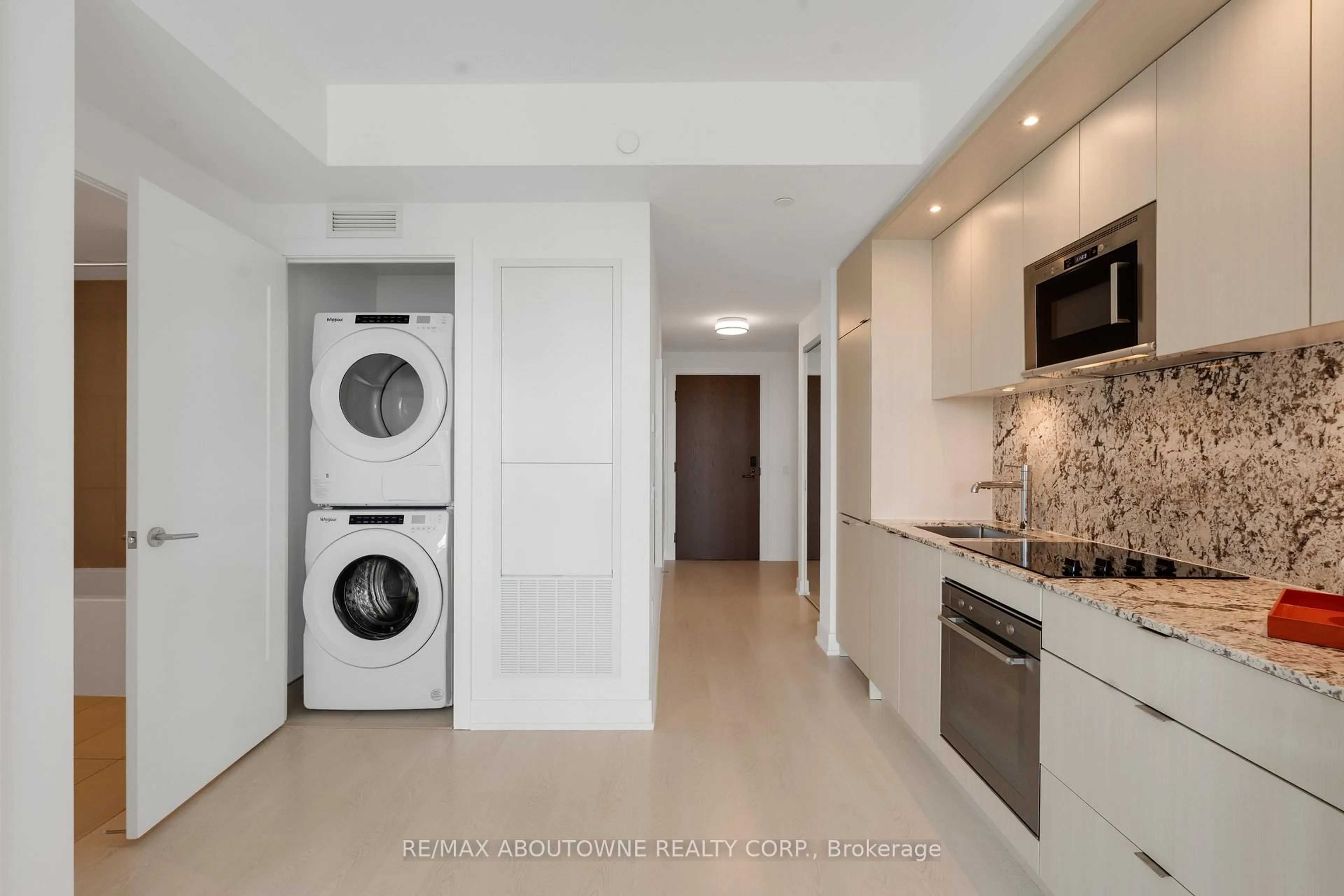 Kitchen with laundary machines, ceramic/tile floor for 30 Inn On The Park Dr #2608, Toronto Ontario M3C 0P7