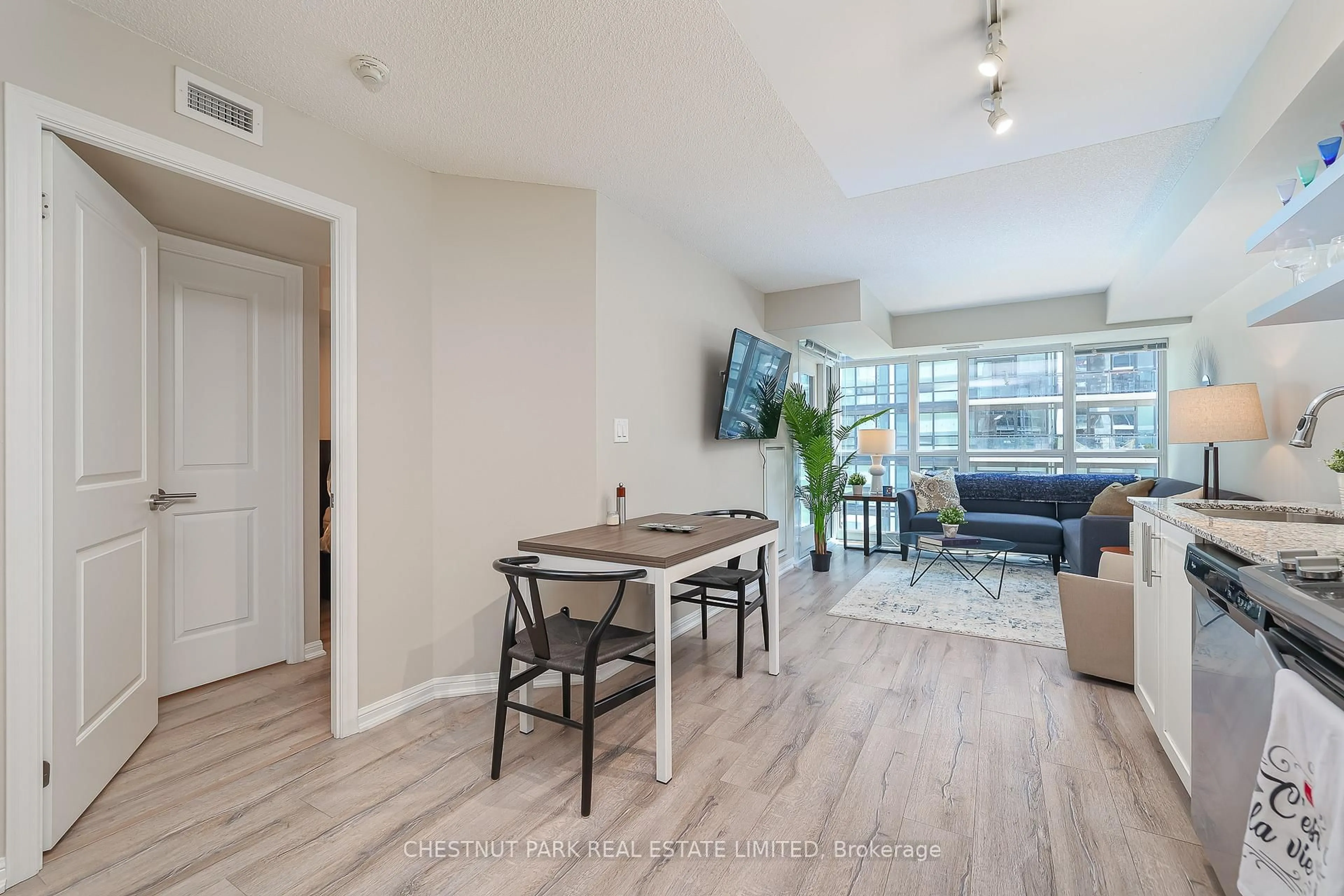 Living room with furniture, wood/laminate floor for 400 Adelaide St #1702, Toronto Ontario M5A 4S3