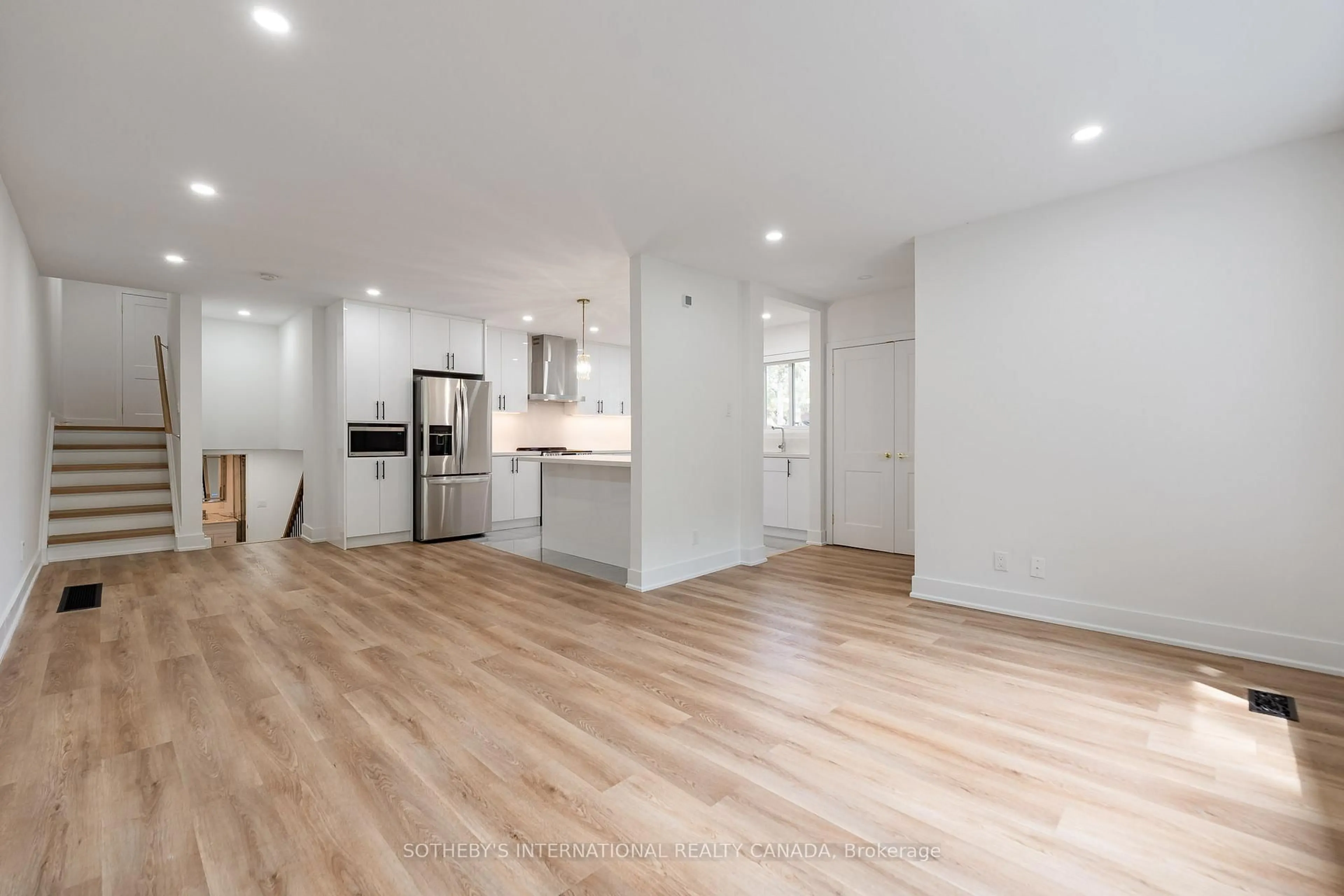 Open concept kitchen, wood/laminate floor for 105 Baltray Cres, Toronto Ontario M3A 2H5