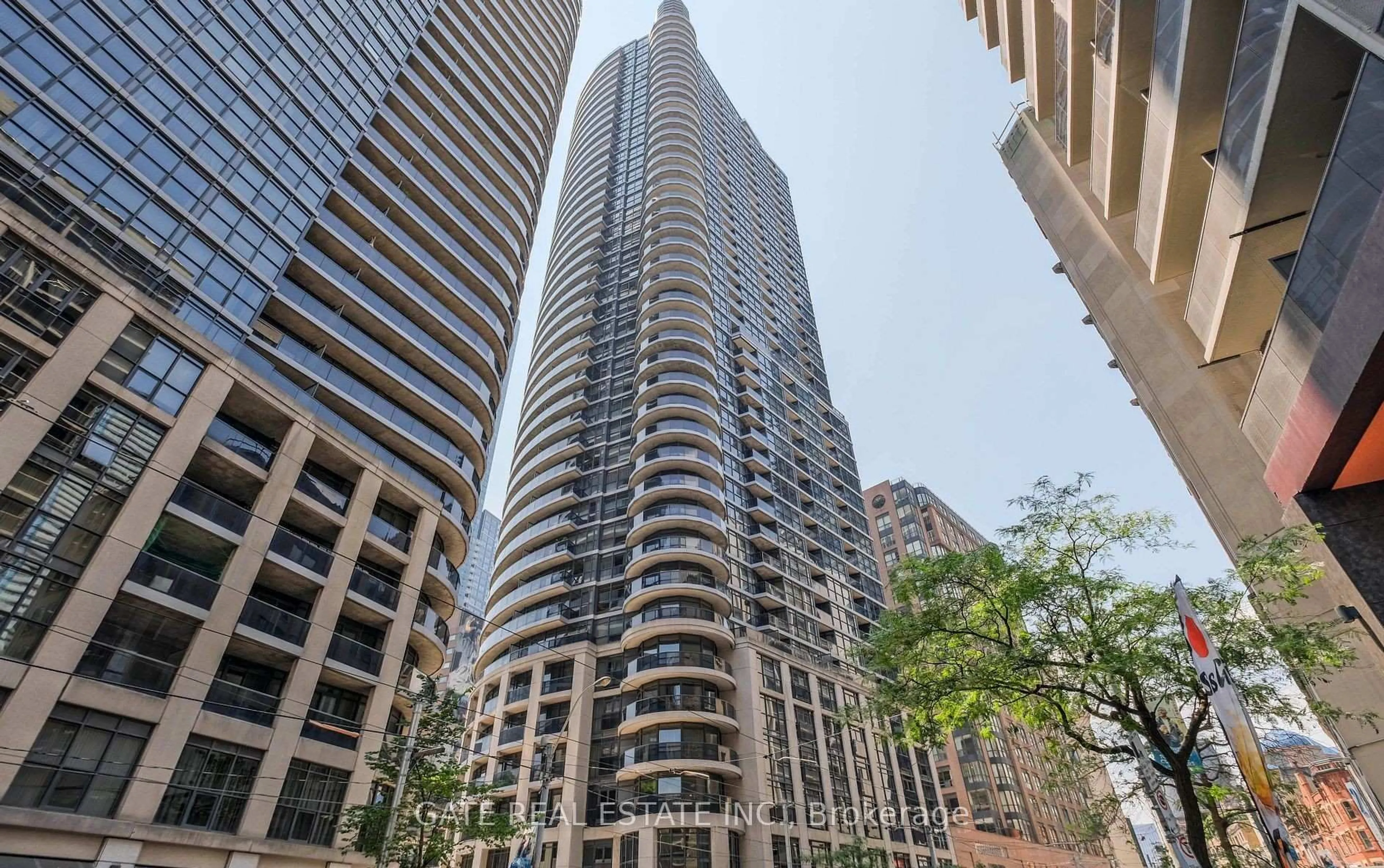 Patio, city buildings view from balcony for 21 Carlton St #1705, Toronto Ontario M5B 1L3