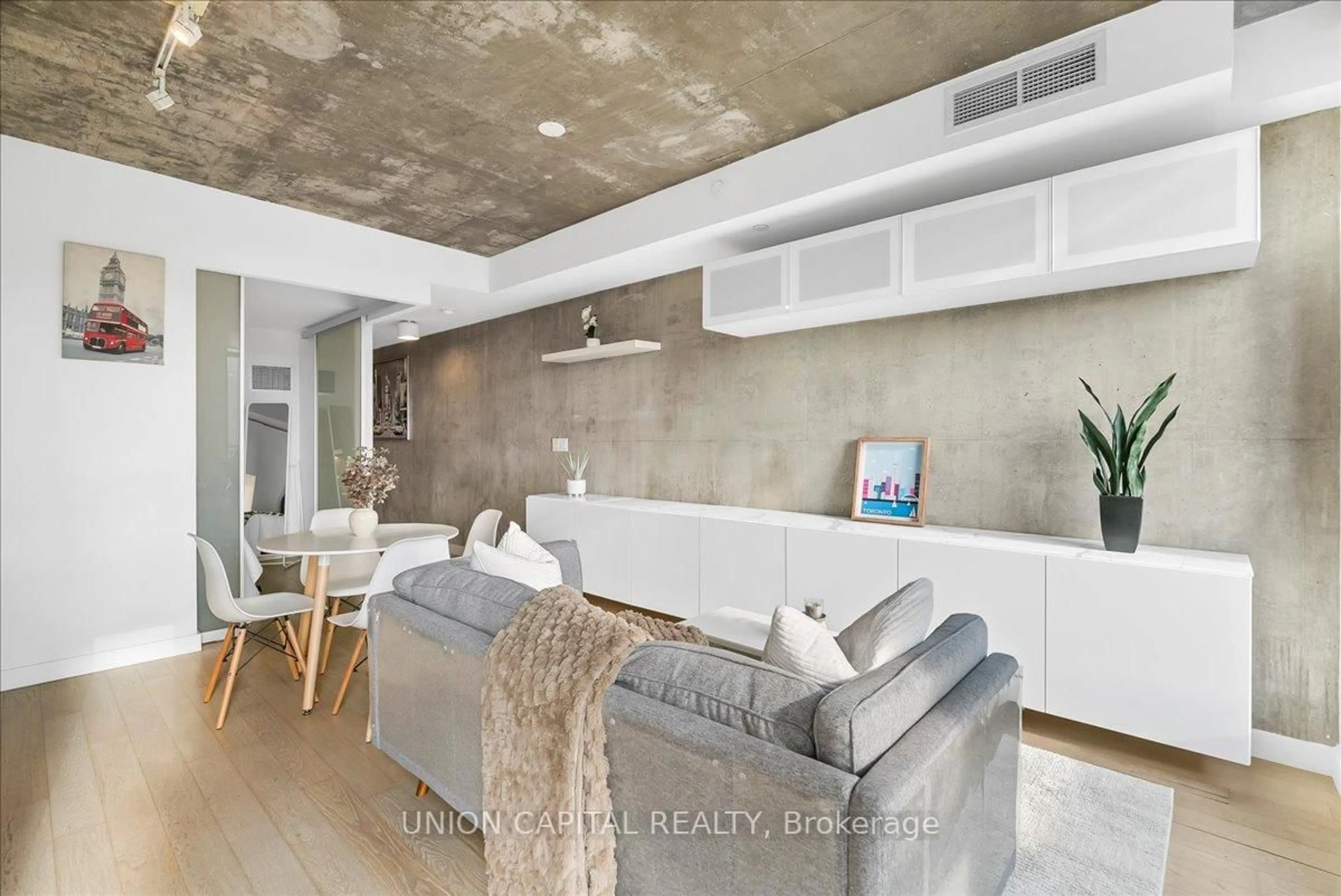 Living room with furniture, cement floor for 111 Bathurst St #505, Toronto Ontario M5V 0M9