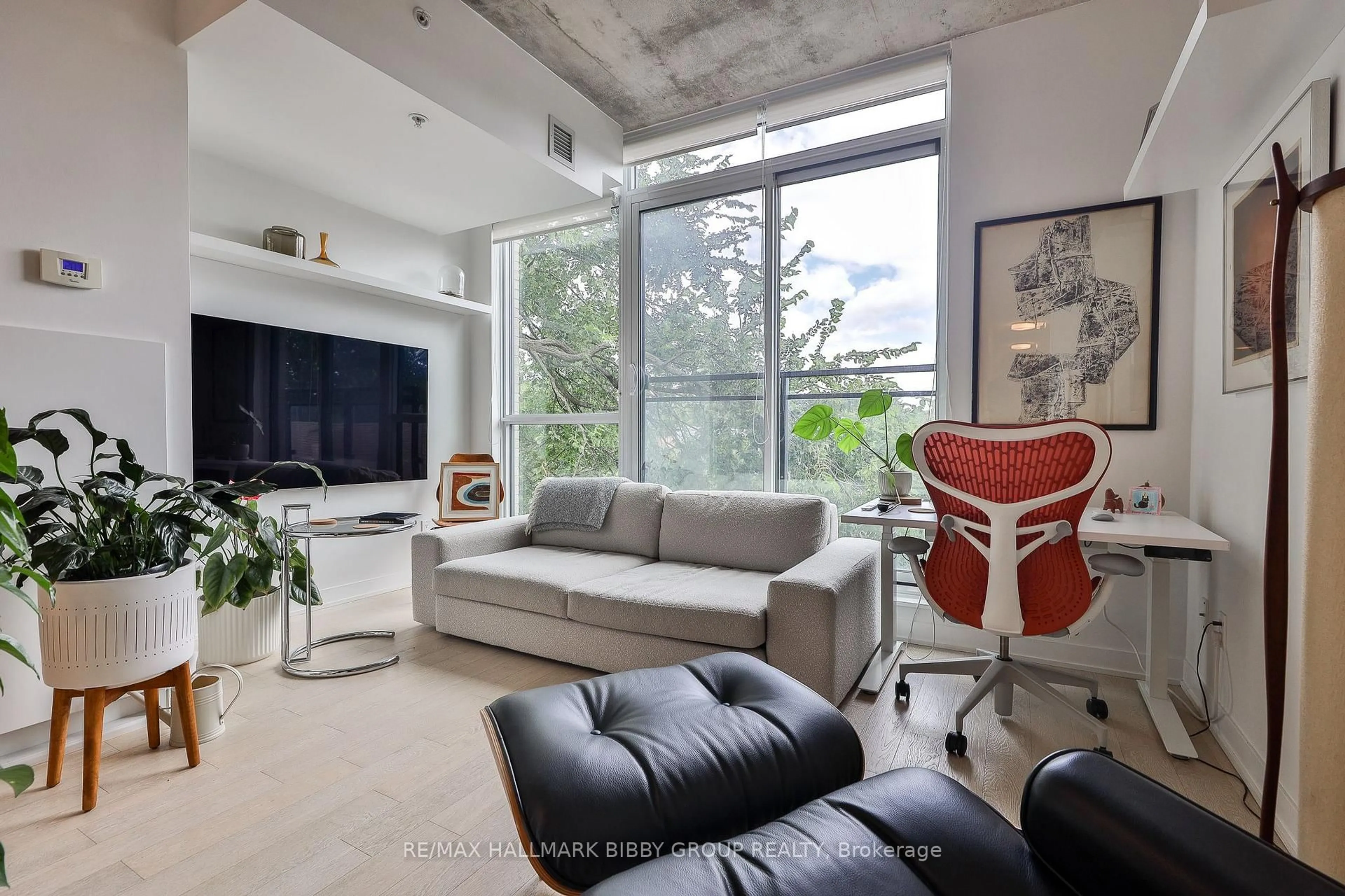 Living room with furniture, cement floor for 130 Rusholme Rd #309, Toronto Ontario M6H 1A7