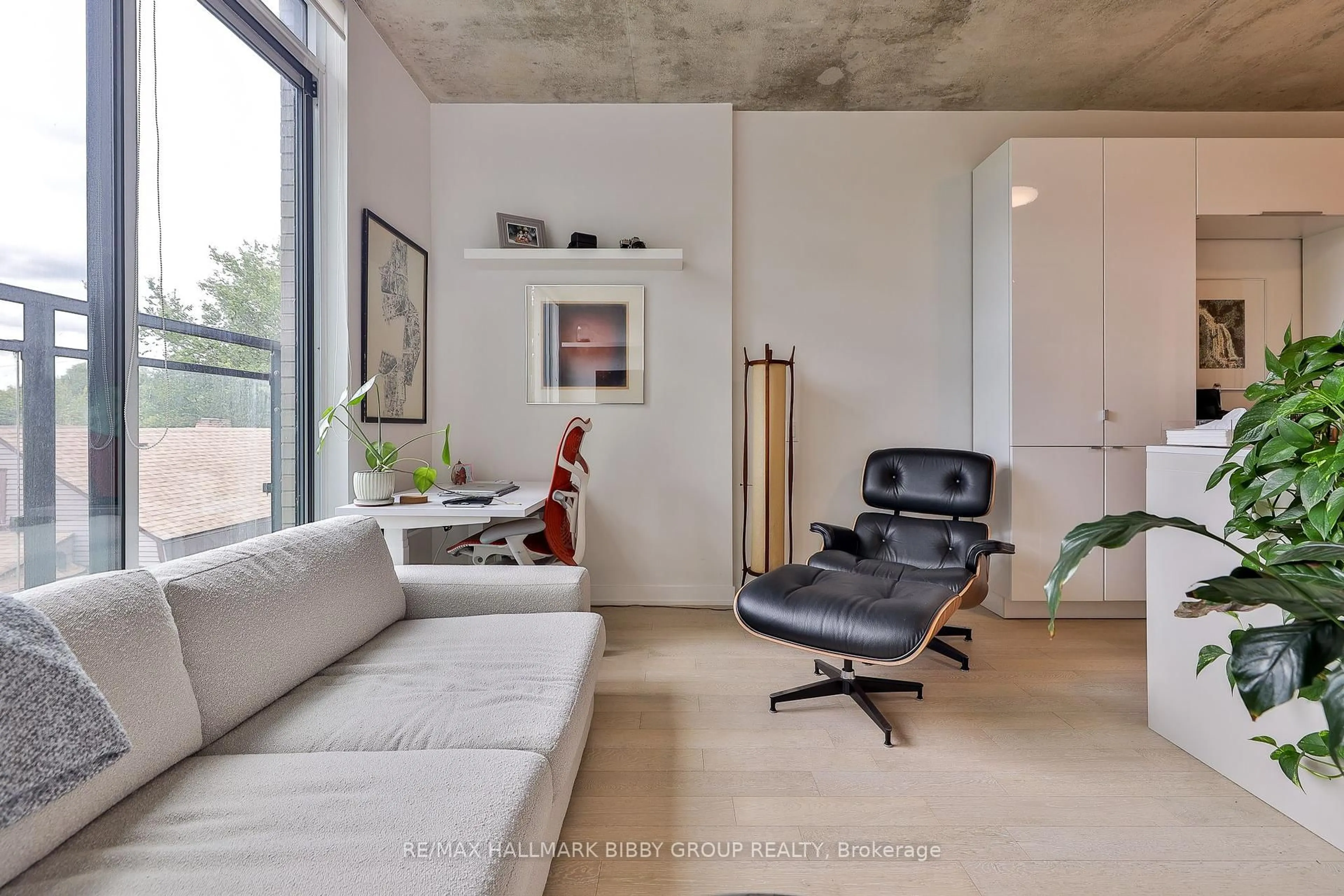 Living room with furniture, cement floor for 130 Rusholme Rd #309, Toronto Ontario M6H 1A7