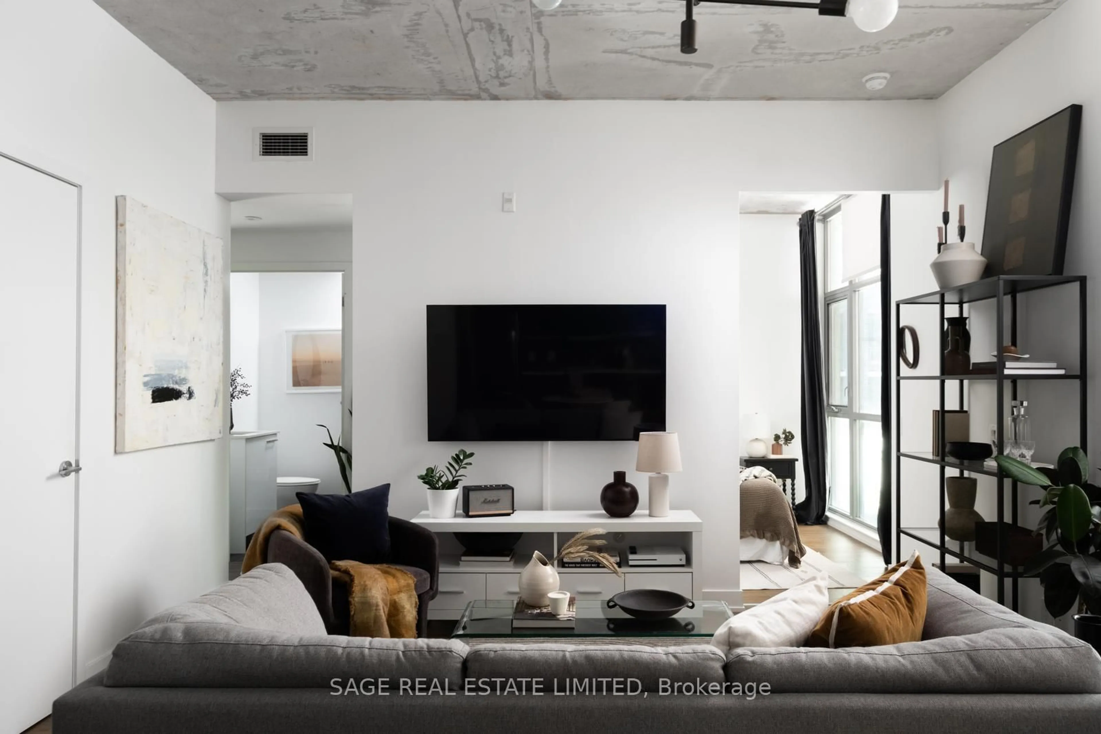 Living room with furniture, cement floor for 2 Gladstone Ave #401, Toronto Ontario M6J 0B2