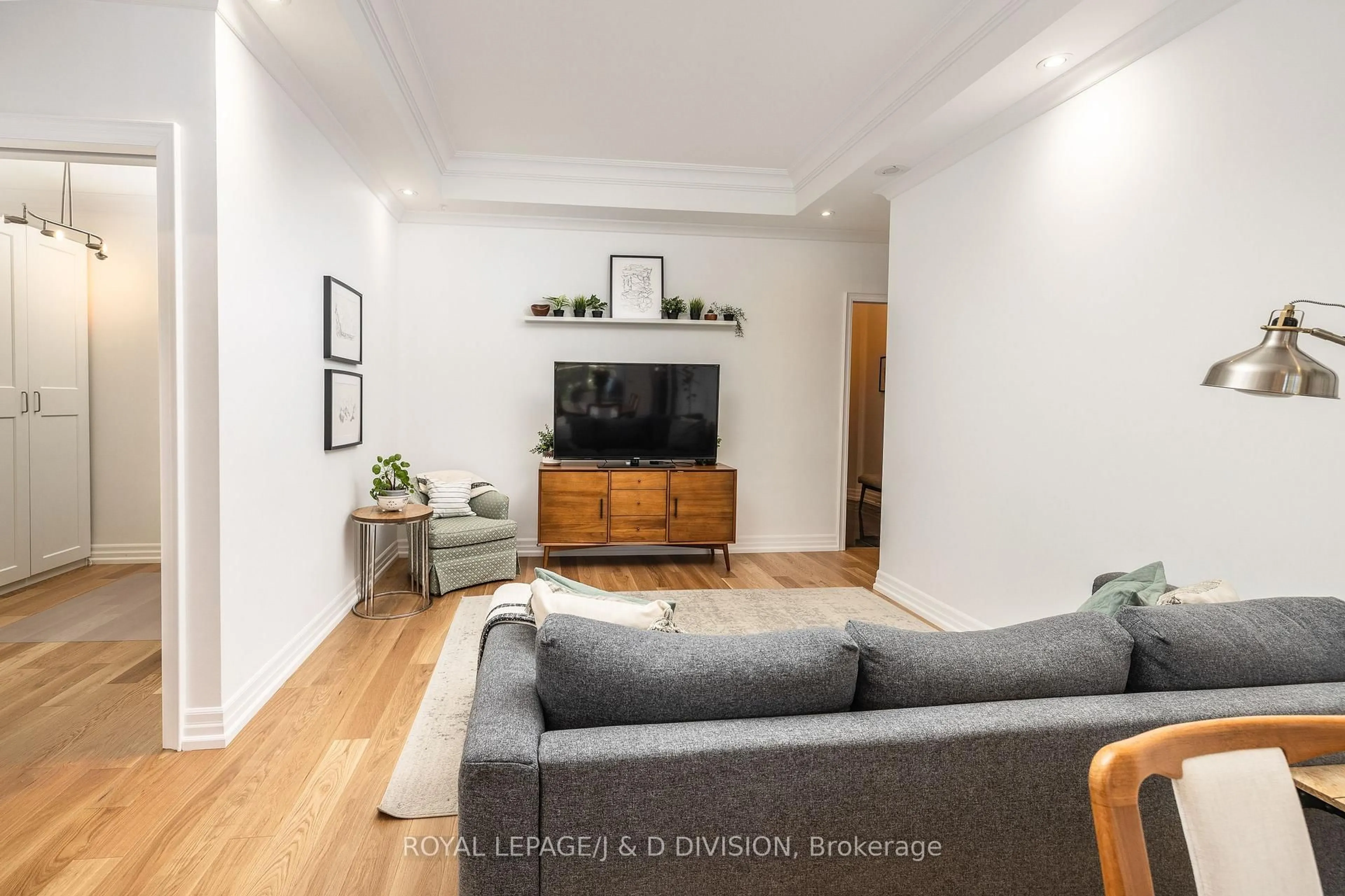 Living room with furniture, wood/laminate floor for 20 Burkebrook Pl #334, Toronto Ontario M4G 0A1