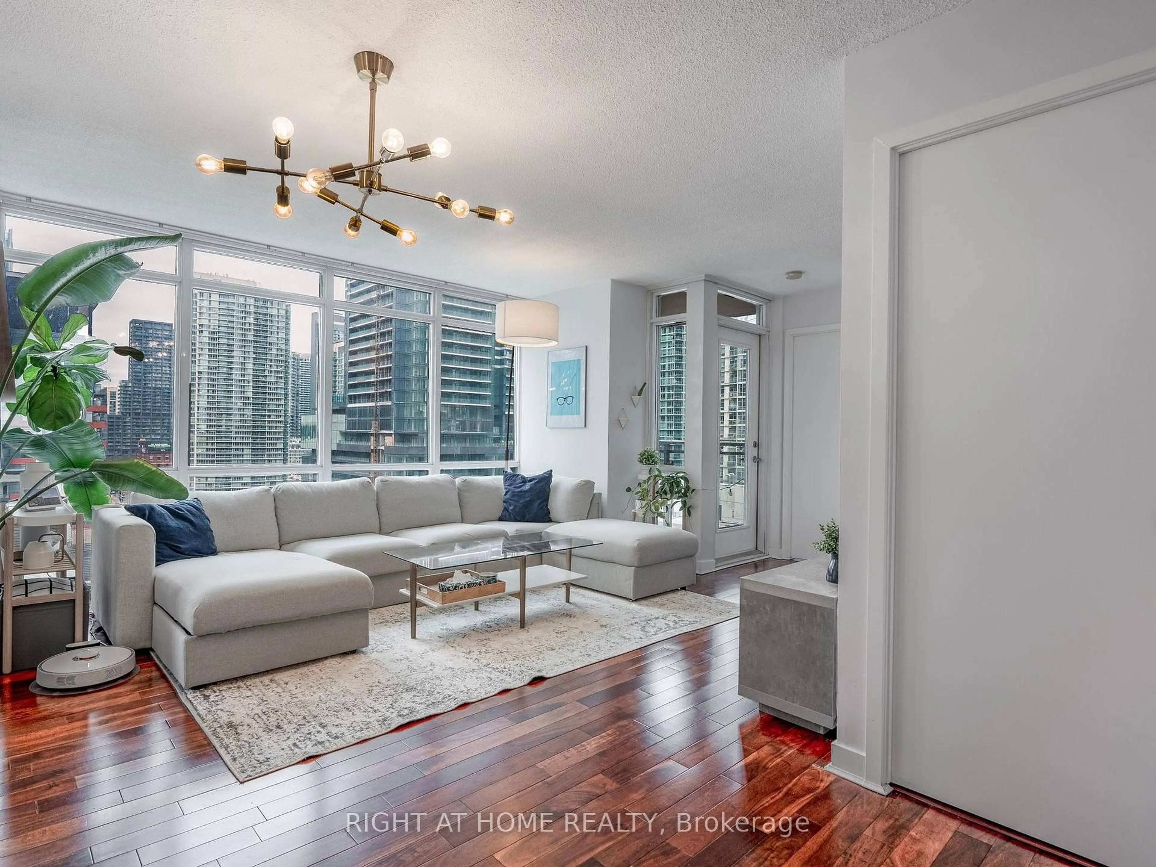 Living room with furniture, wood/laminate floor for 11 Brunel Crt #1706, Toronto Ontario M5V 3Y3