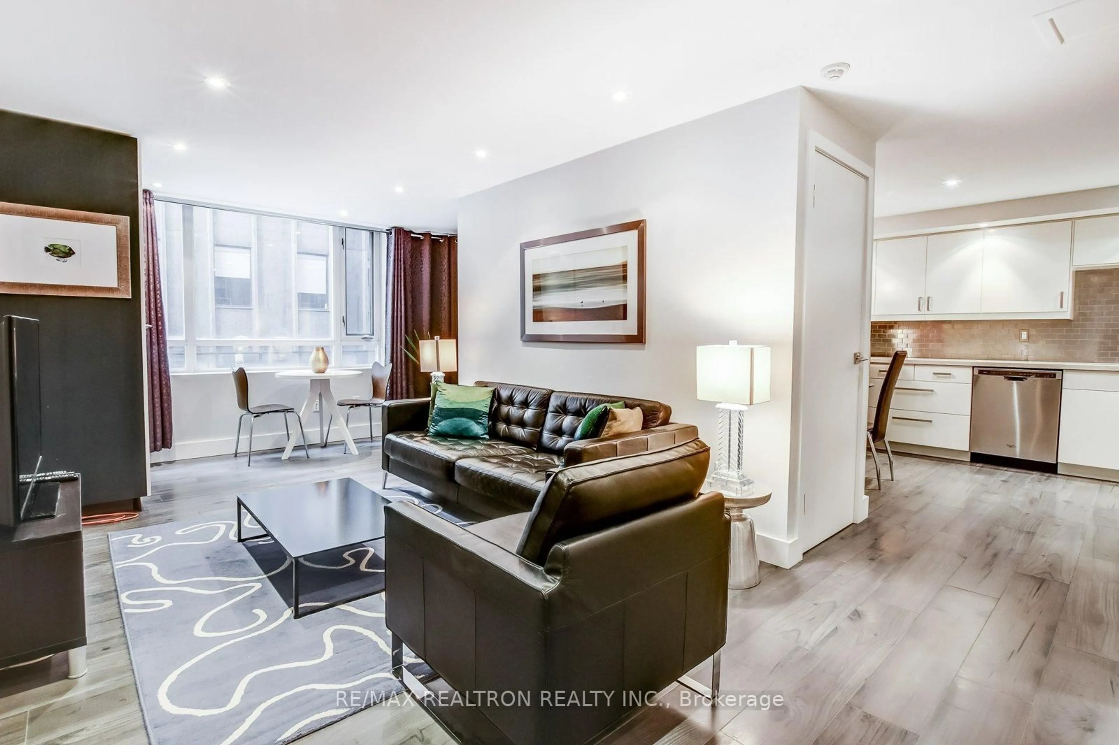 Living room with furniture, wood/laminate floor for 80 Cumberland St #301, Toronto Ontario M5R 3V1