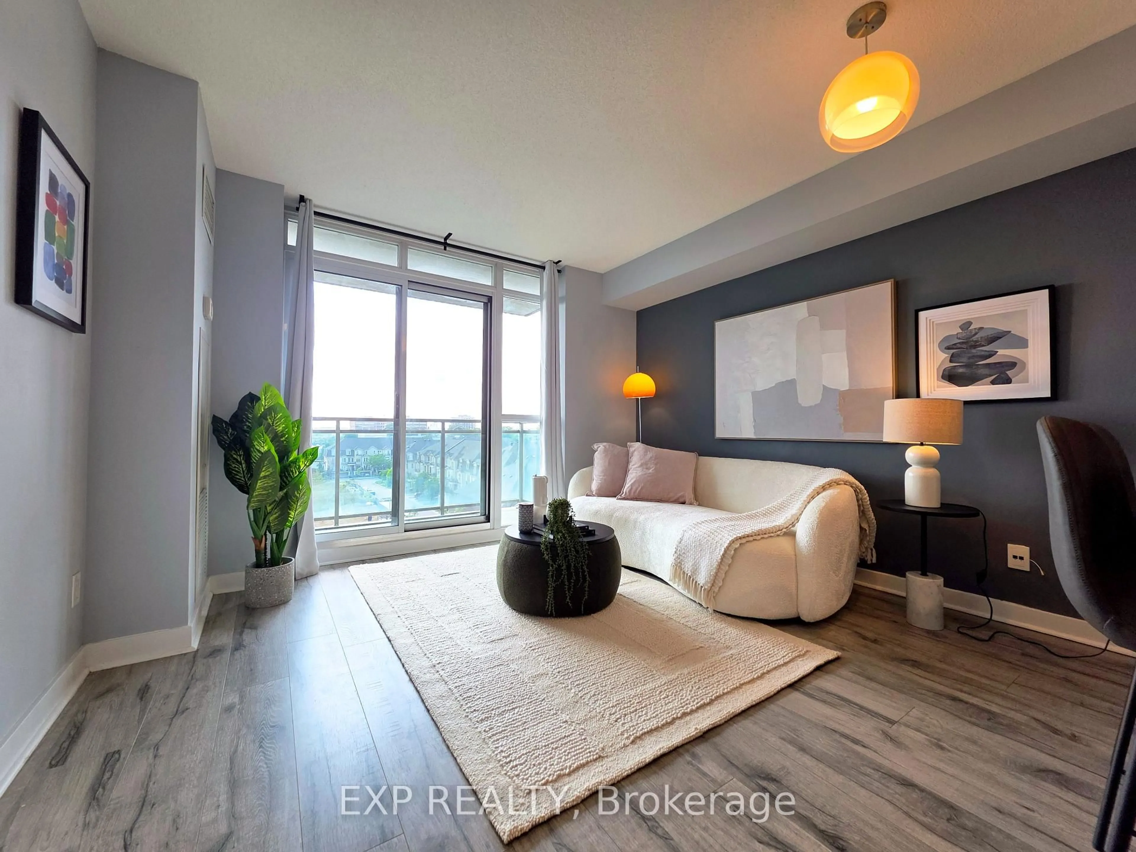 Living room with furniture, wood/laminate floor for 120 Dallimore Circ #723, Toronto Ontario M3C 4J1