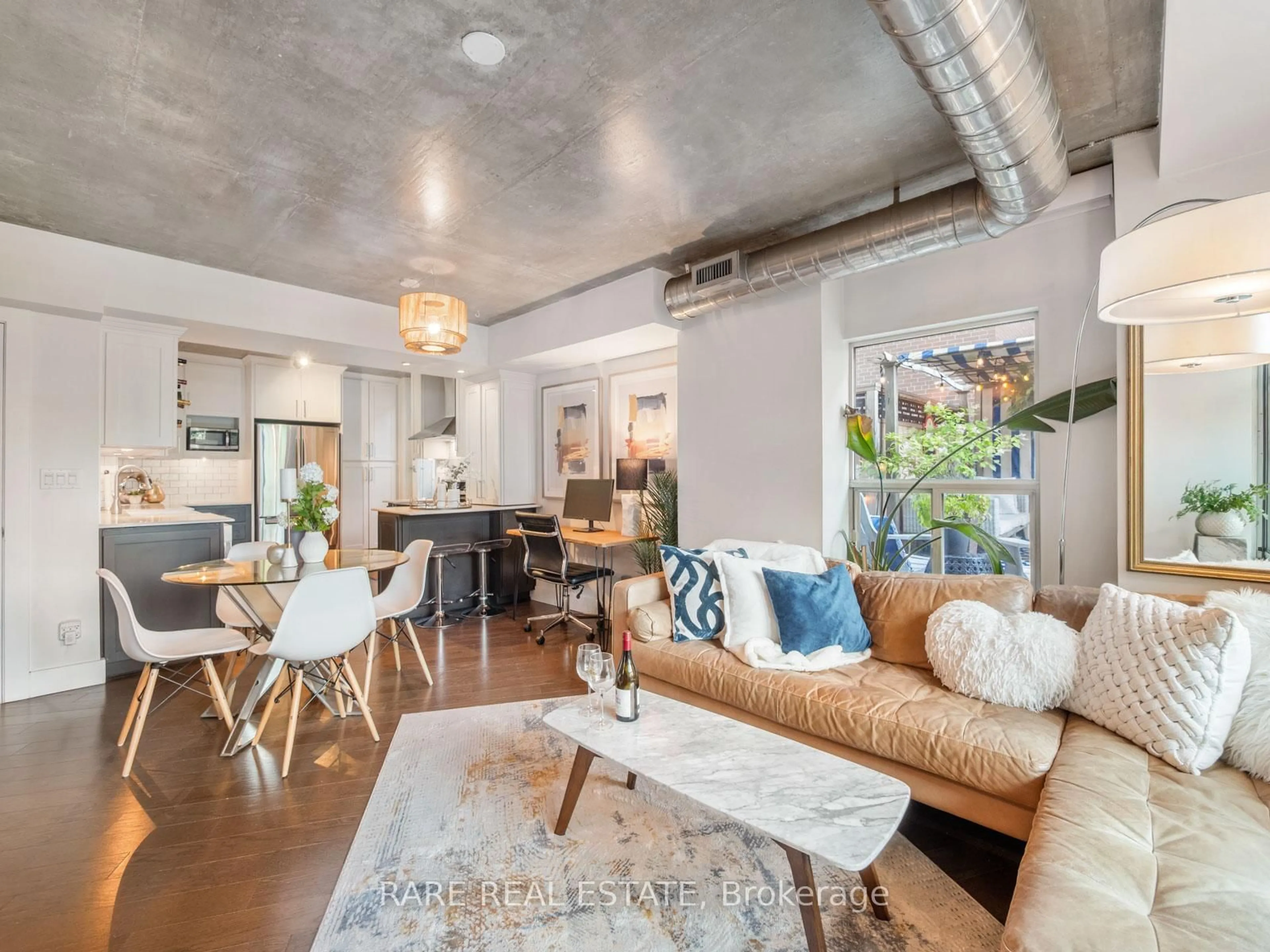 Living room with furniture, cement floor for 77 Lombard St #202, Toronto Ontario M5C 3E1