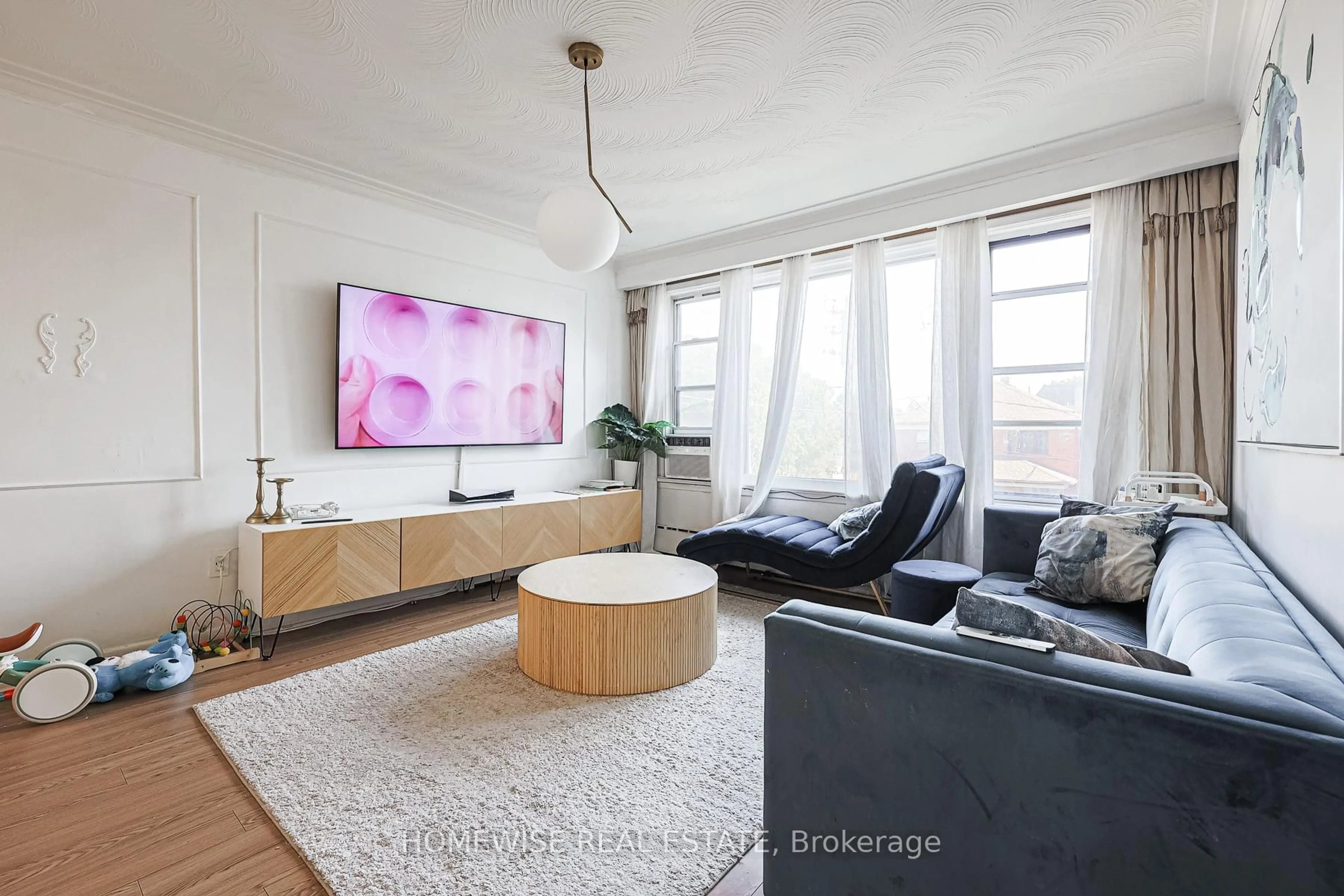 Living room with furniture, wood/laminate floor for 4 Lanark Ave, Toronto Ontario M6C 2B3