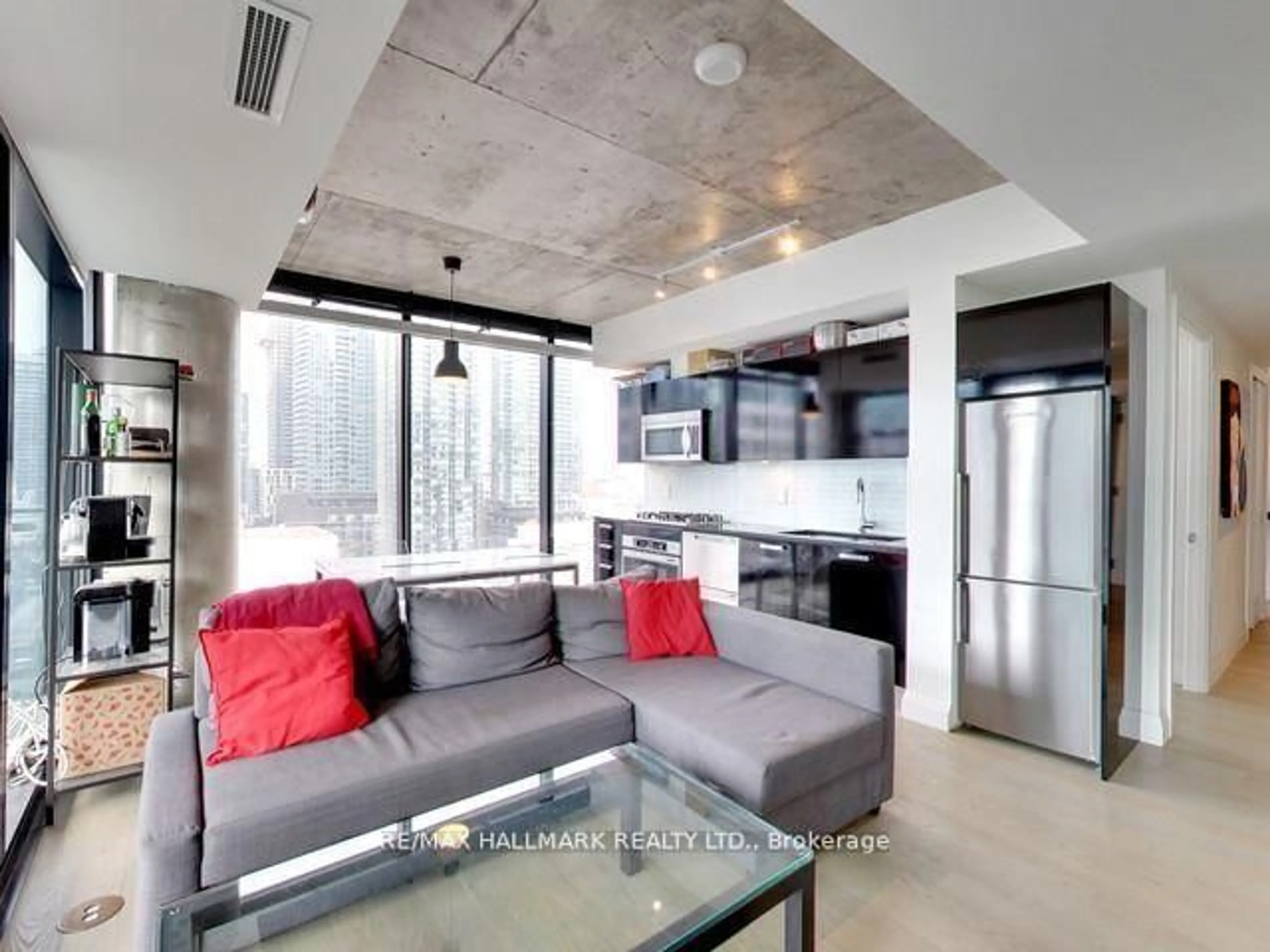 Living room with furniture, cement floor for 224 King St #1407, Toronto Ontario M5H 0A6