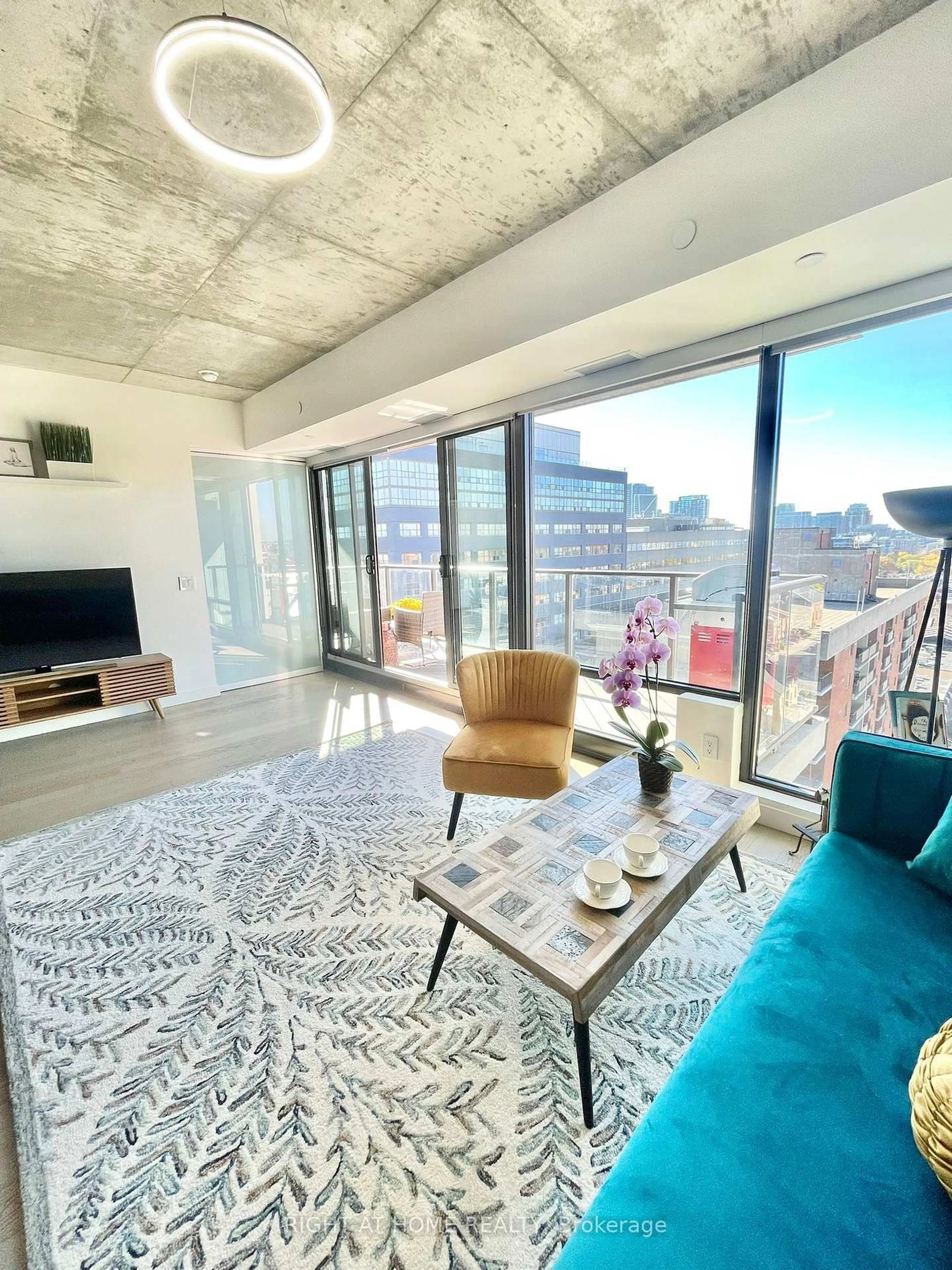 Living room with furniture, cement floor for 111 Bathurst St #1205, Toronto Ontario M5V 2R1