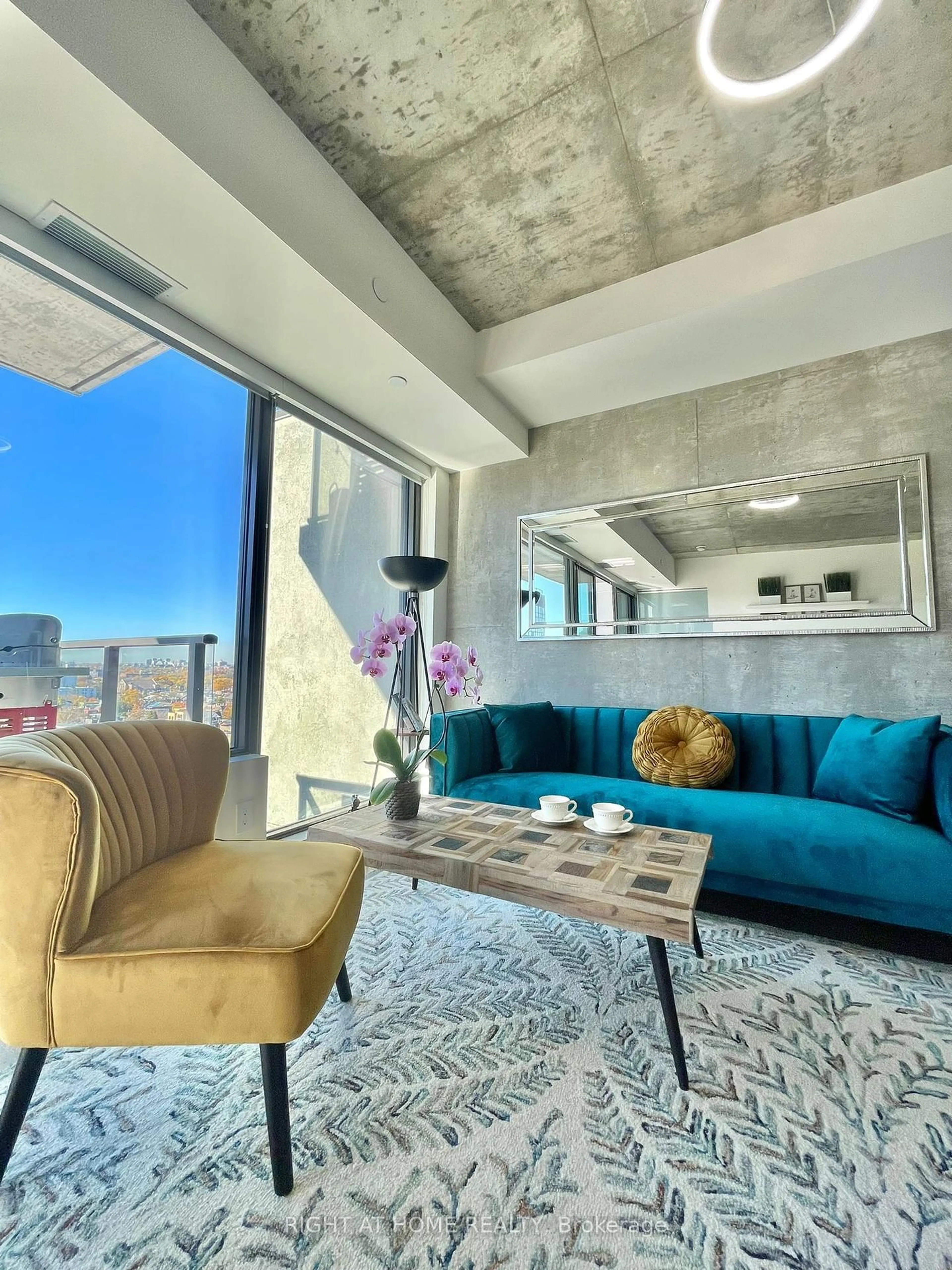 Living room with furniture, cement floor for 111 Bathurst St #1205, Toronto Ontario M5V 2R1