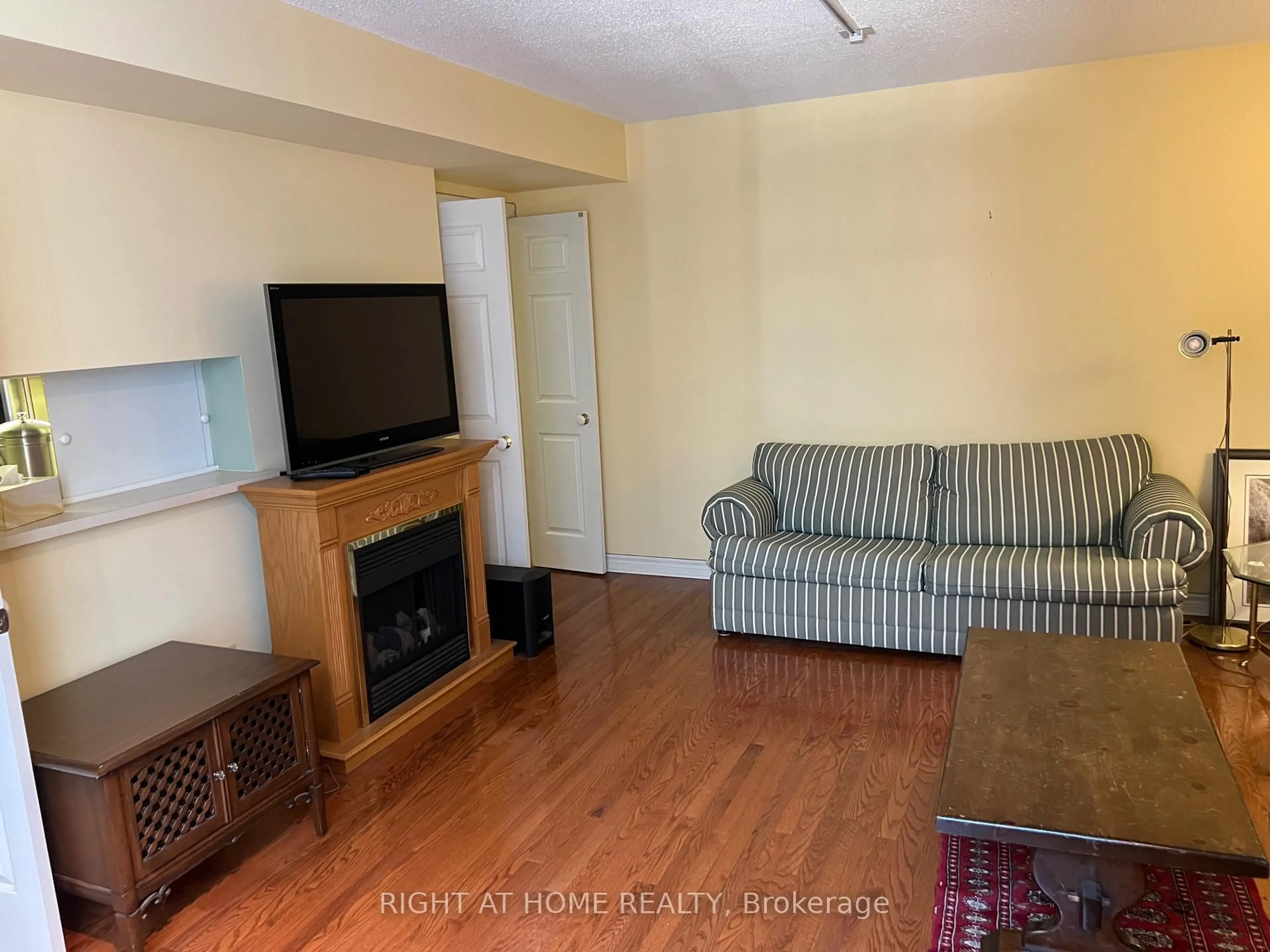 Living room with furniture, wood/laminate floor for 71 Simcoe St #705, Toronto Ontario M5J 2S9