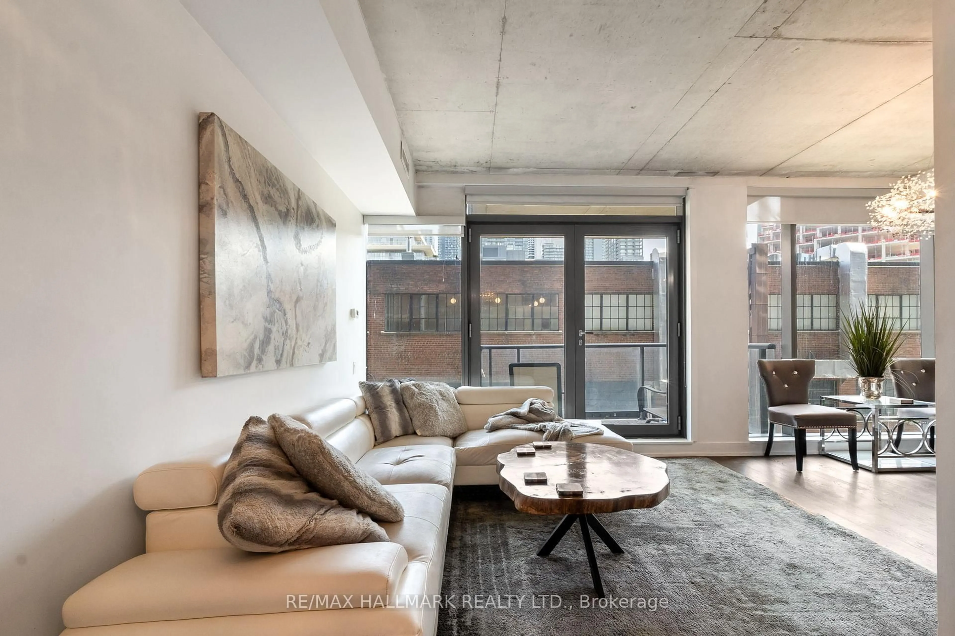Living room with furniture, cement floor for 560 King St #206, Toronto Ontario M5V 0L6