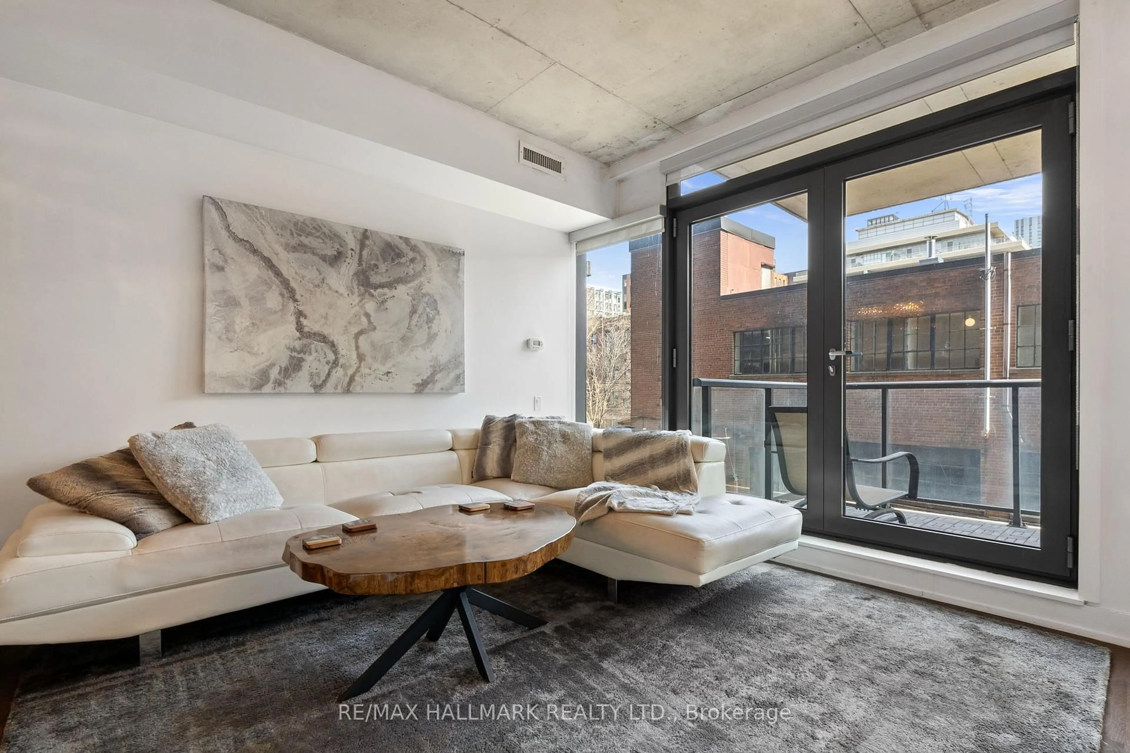 Living room with furniture, cement floor for 560 King St #206, Toronto Ontario M5V 0L6