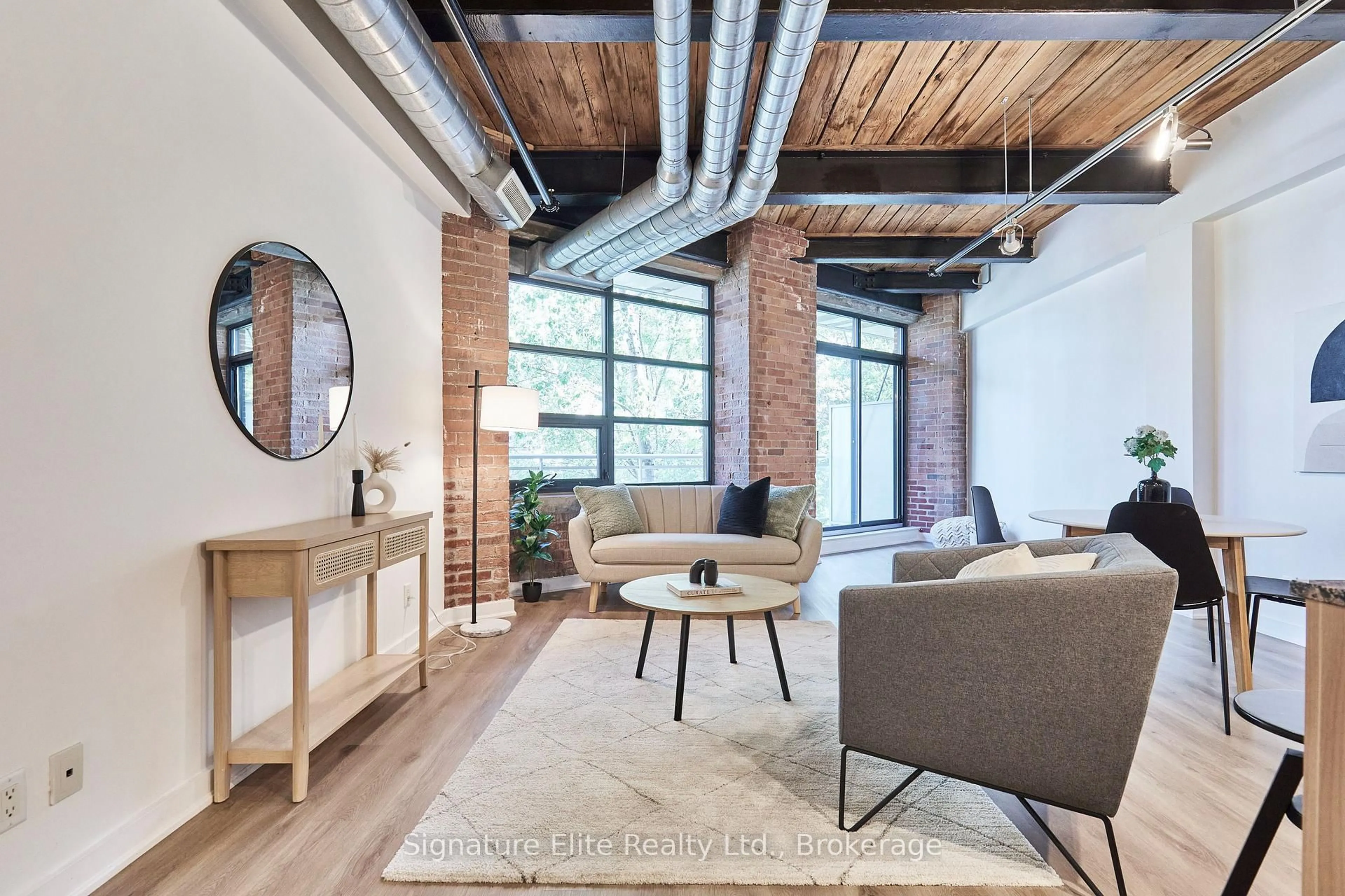 Living room with furniture, cement floor for 43 Hanna Ave #207, Toronto Ontario M6K 1X6