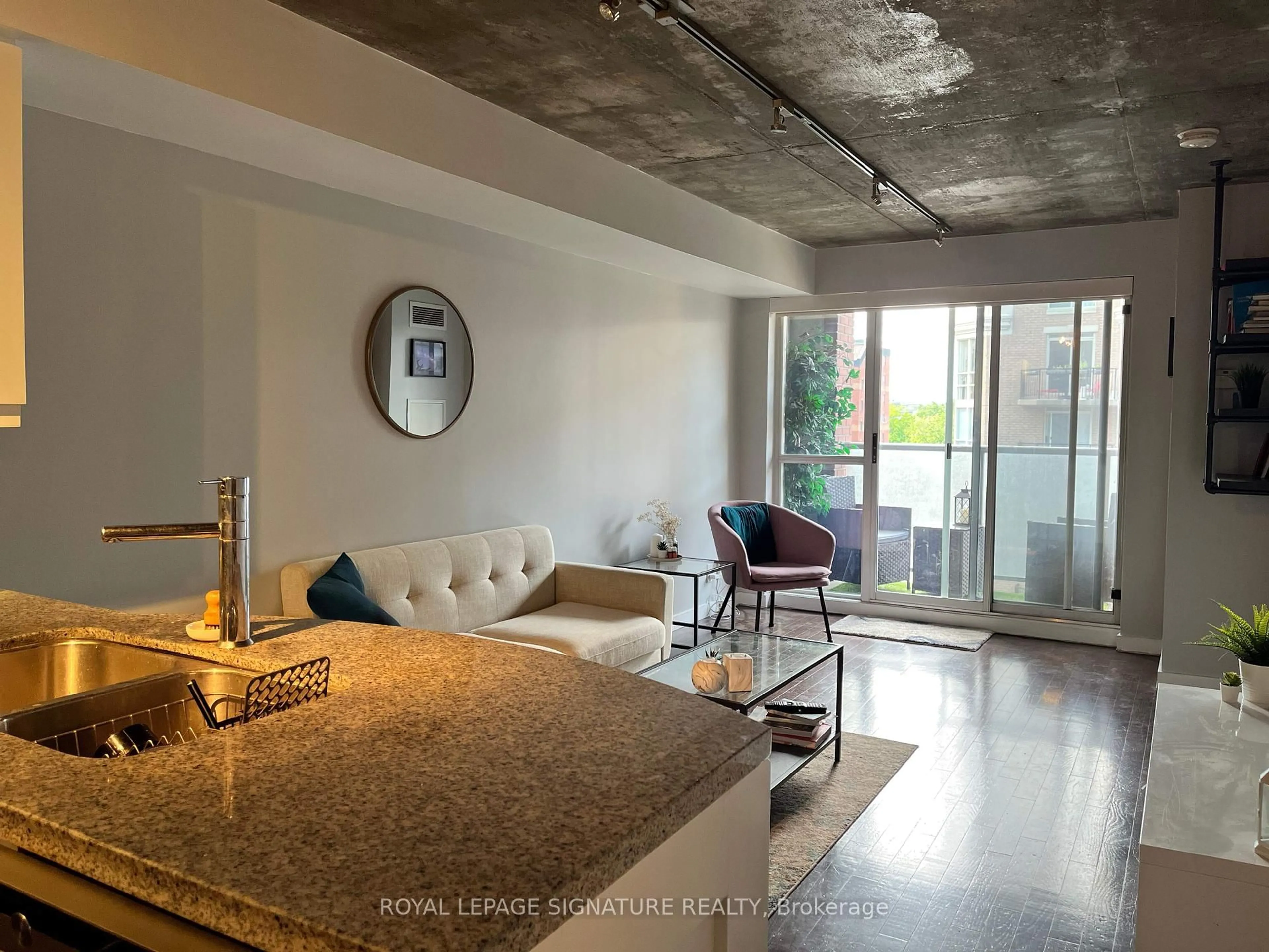 Living room with furniture, cement floor for 1005 King St #610, Toronto Ontario M6K 3M8