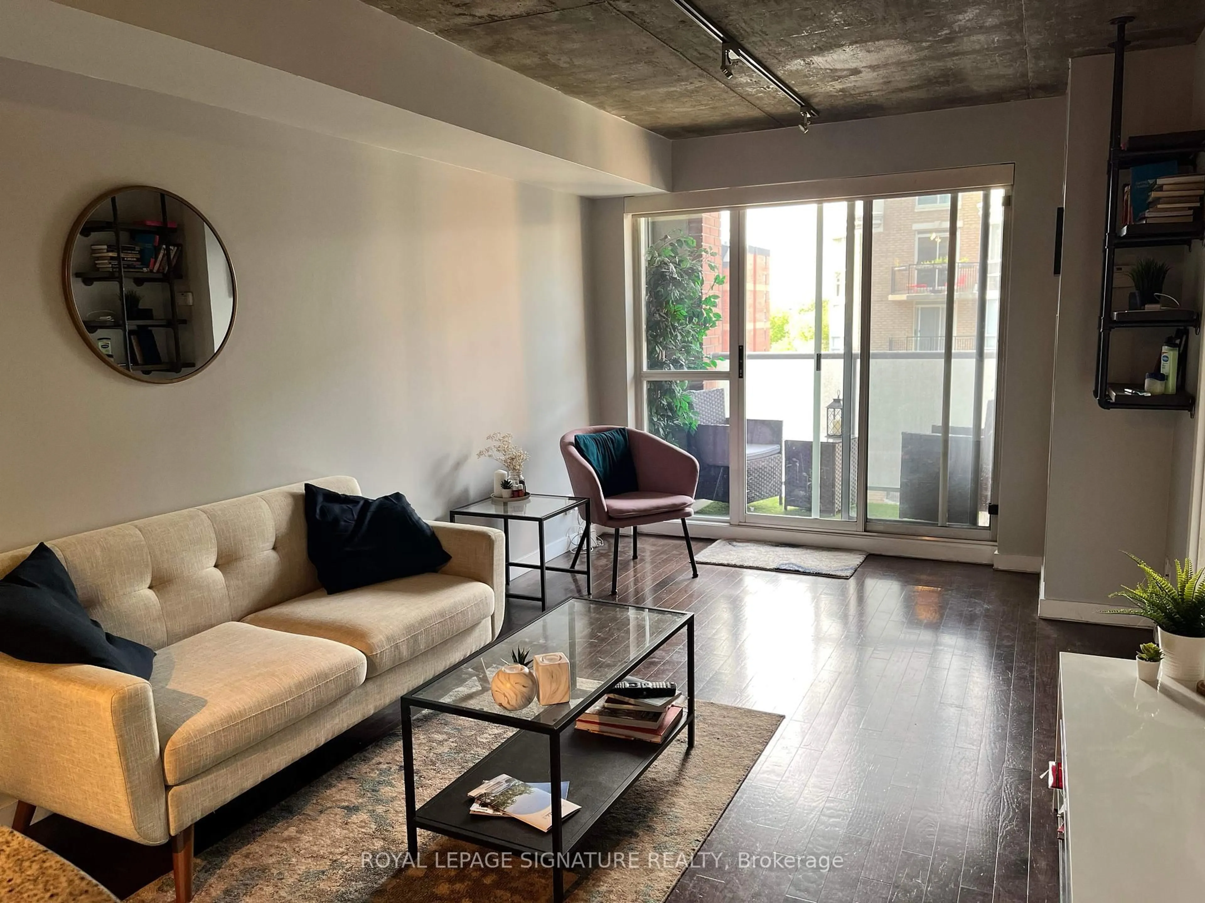 Living room with furniture, cement floor for 1005 King St #610, Toronto Ontario M6K 3M8