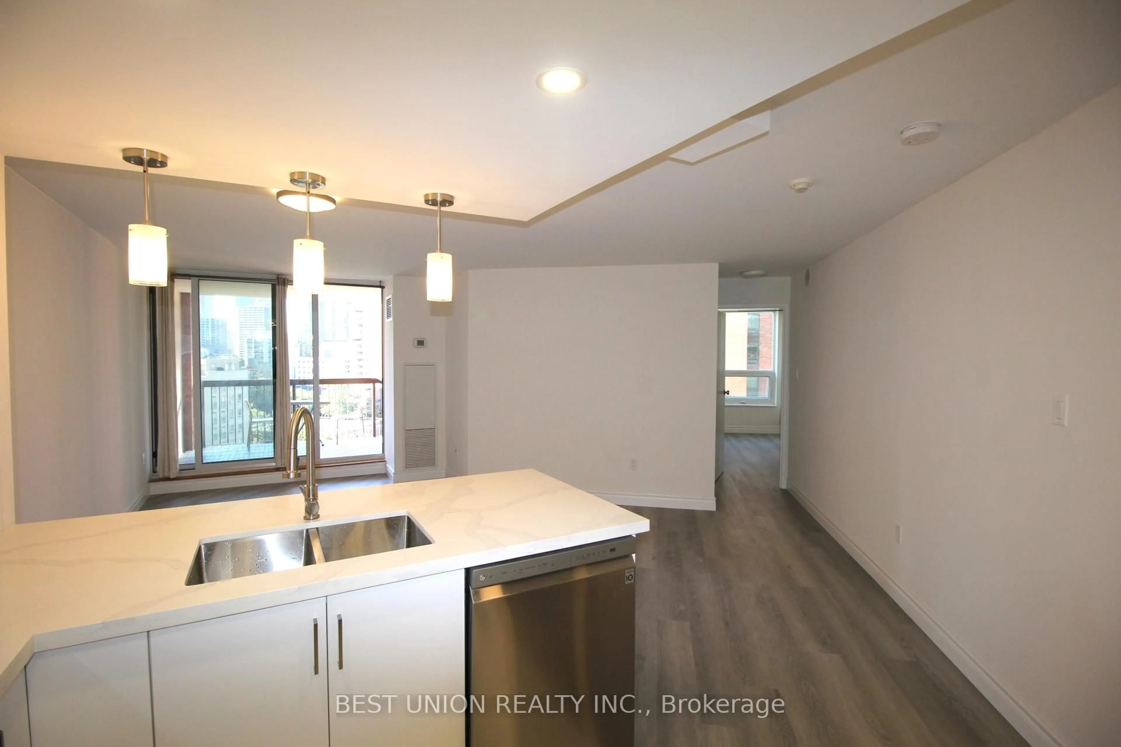Open concept kitchen, wood/laminate floor for 77 Maitland Pl #1209, Toronto Ontario M4Y 2V6