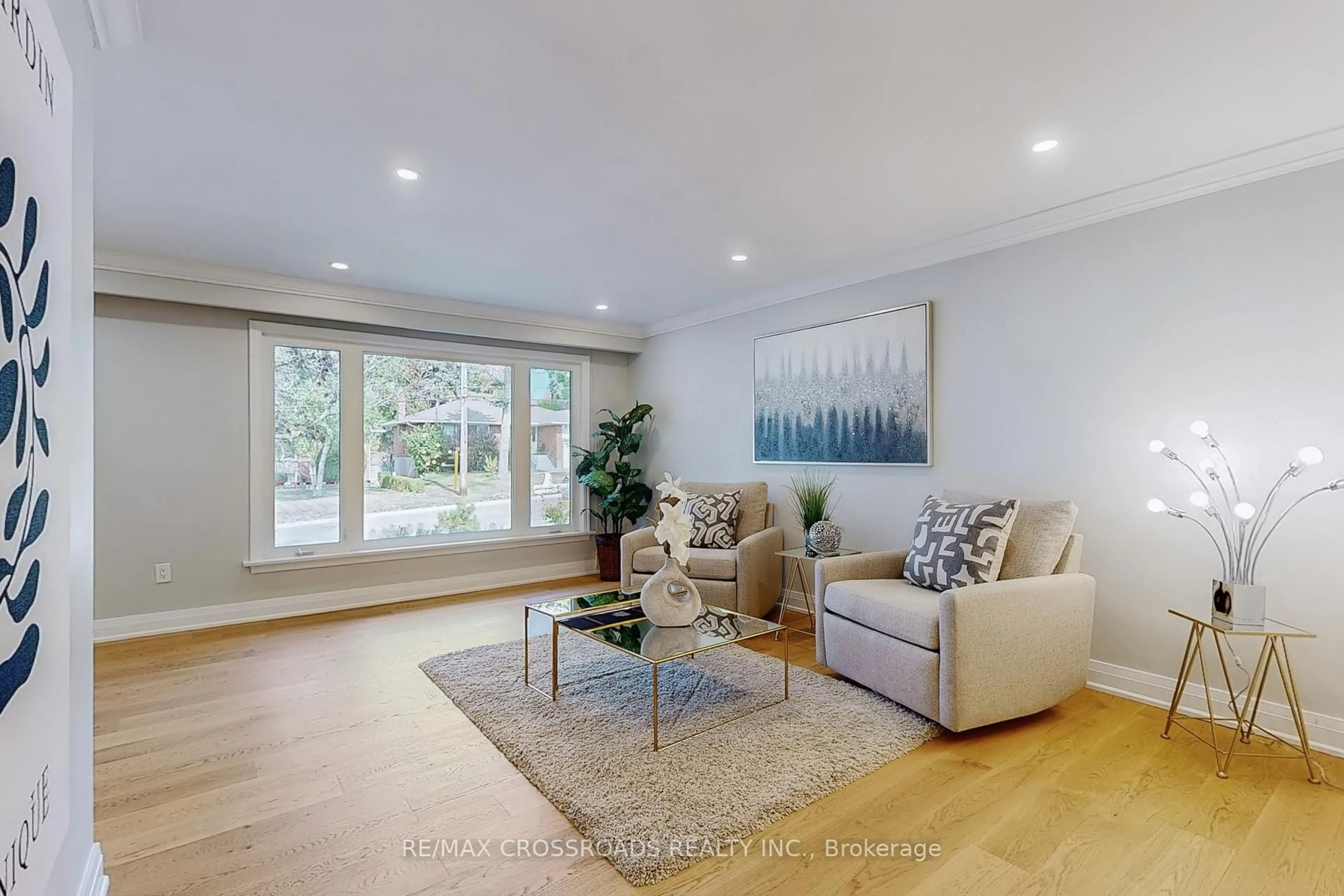 Living room with furniture, wood/laminate floor for 55 Elvaston Dr, Toronto Ontario M4A 1N2