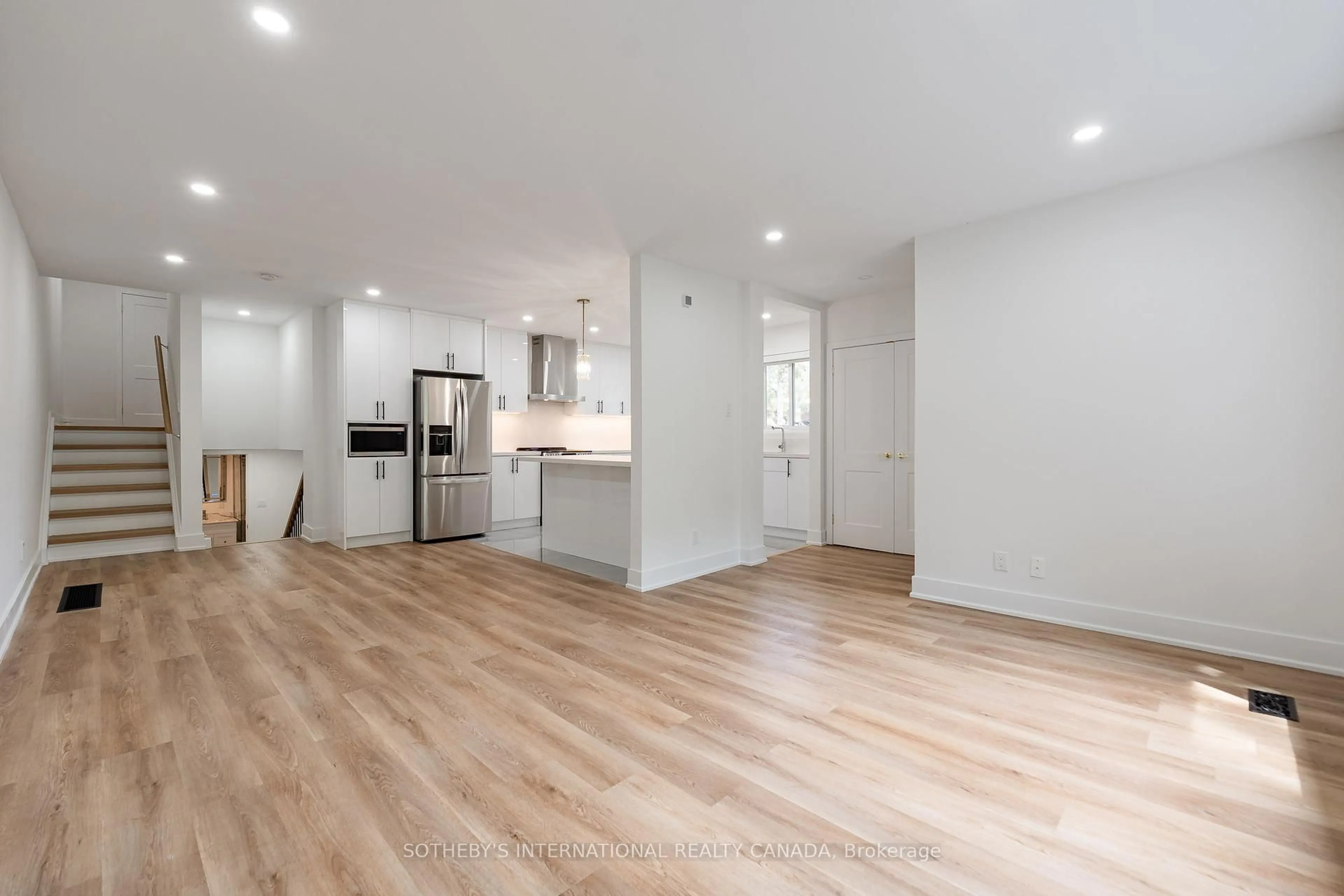 Open concept kitchen, wood/laminate floor for 105 Baltray Cres, Toronto Ontario M3A 2H5