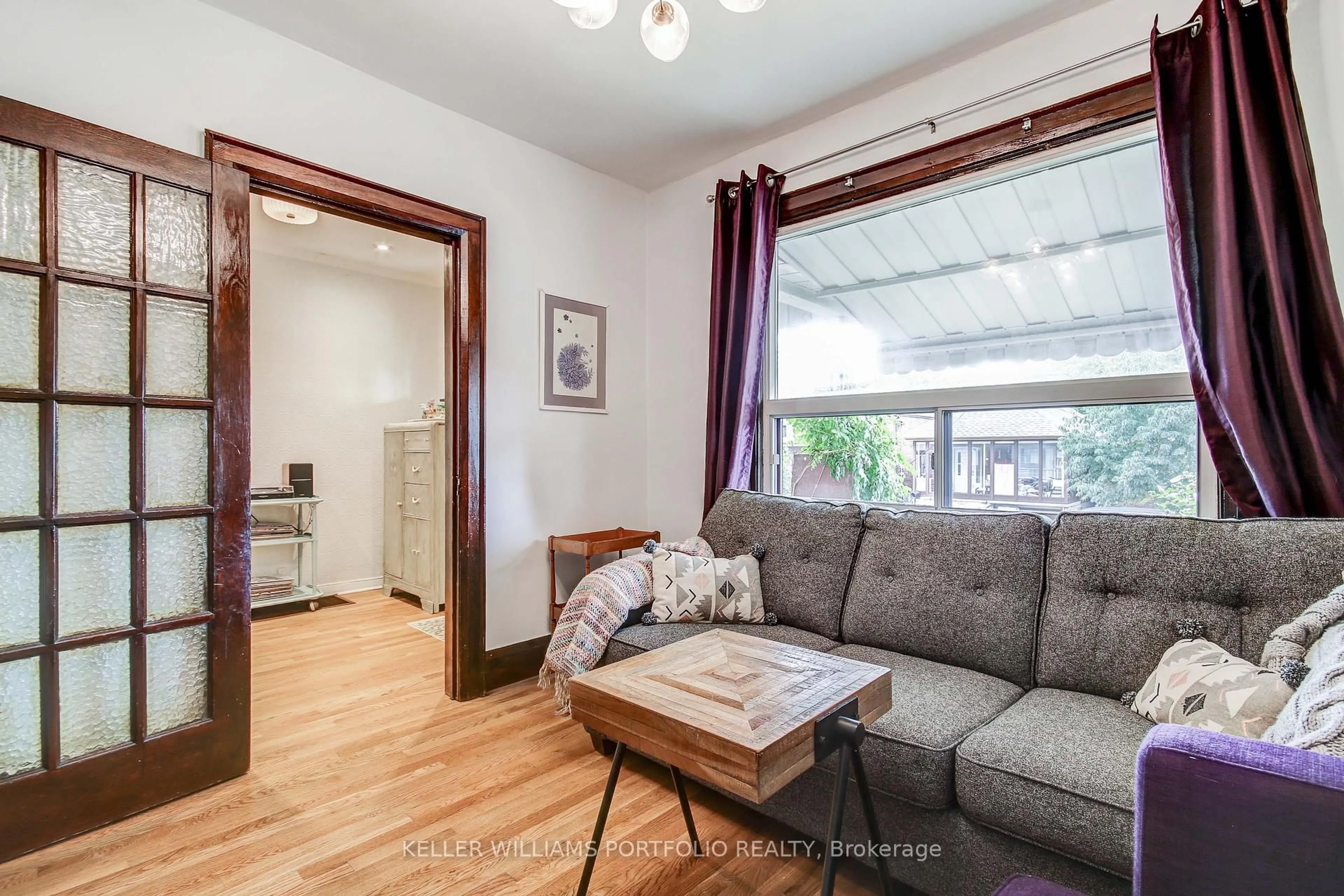 Living room with furniture, wood/laminate floor for 108 Clovelly Ave, Toronto Ontario M6E 2E6