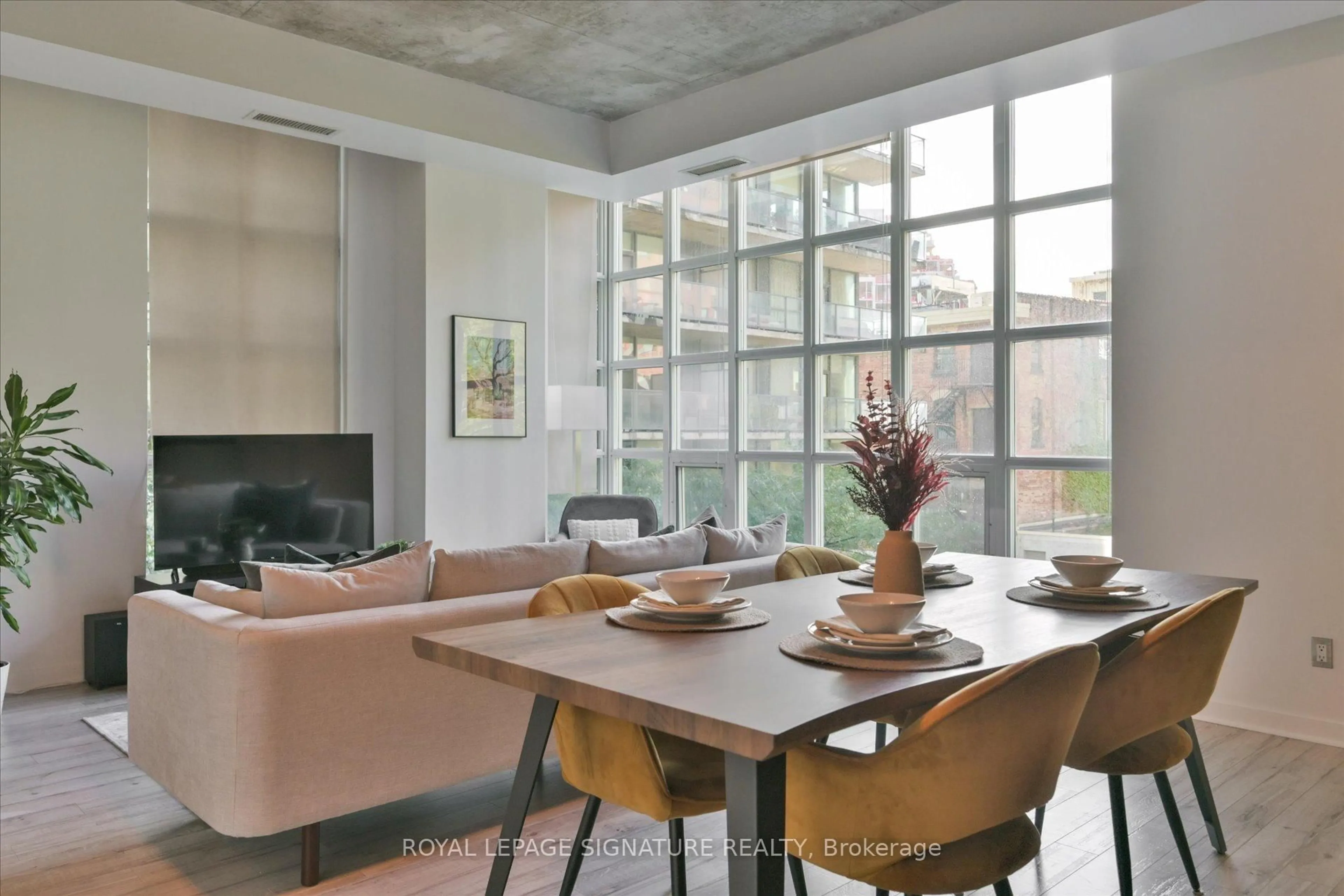 Living room with furniture, cement floor for 23 Brant St #305, Toronto Ontario M5V 2L5