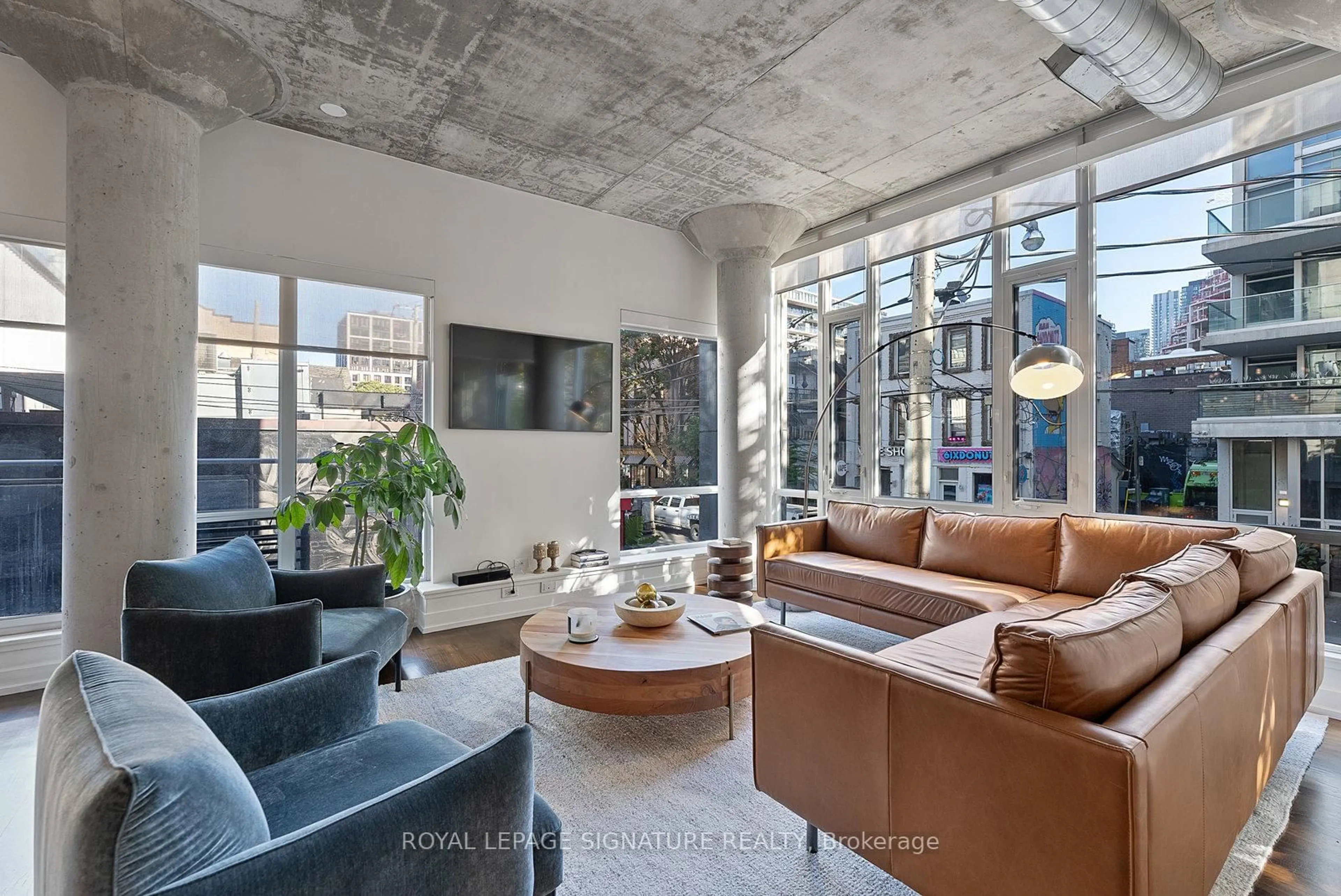 Living room with furniture, cement floor for 66 Portland St #201, Toronto Ontario M5V 2M6
