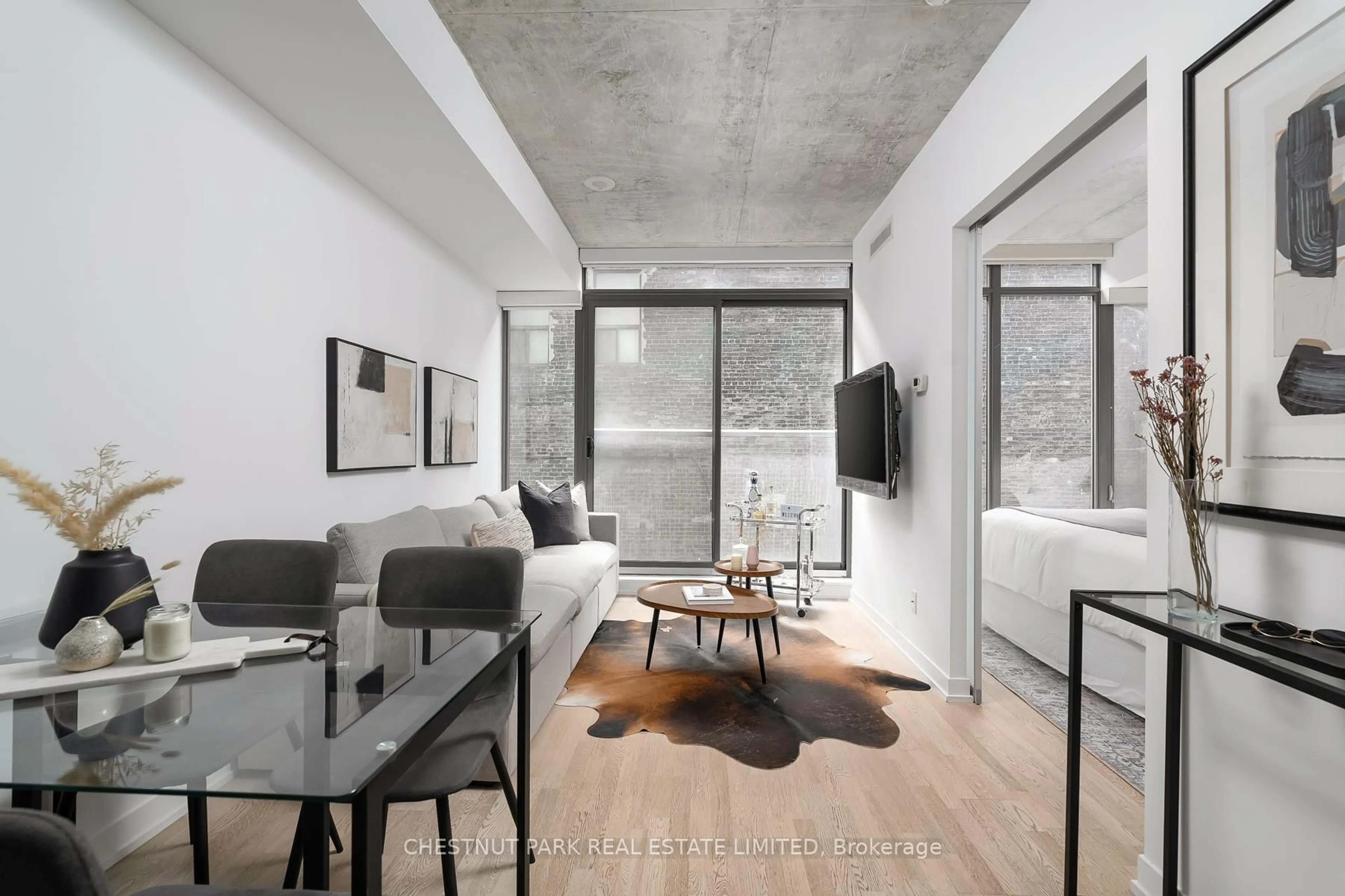 Living room with furniture, cement floor for 461 Adelaide St #230, Toronto Ontario M5V 0L6