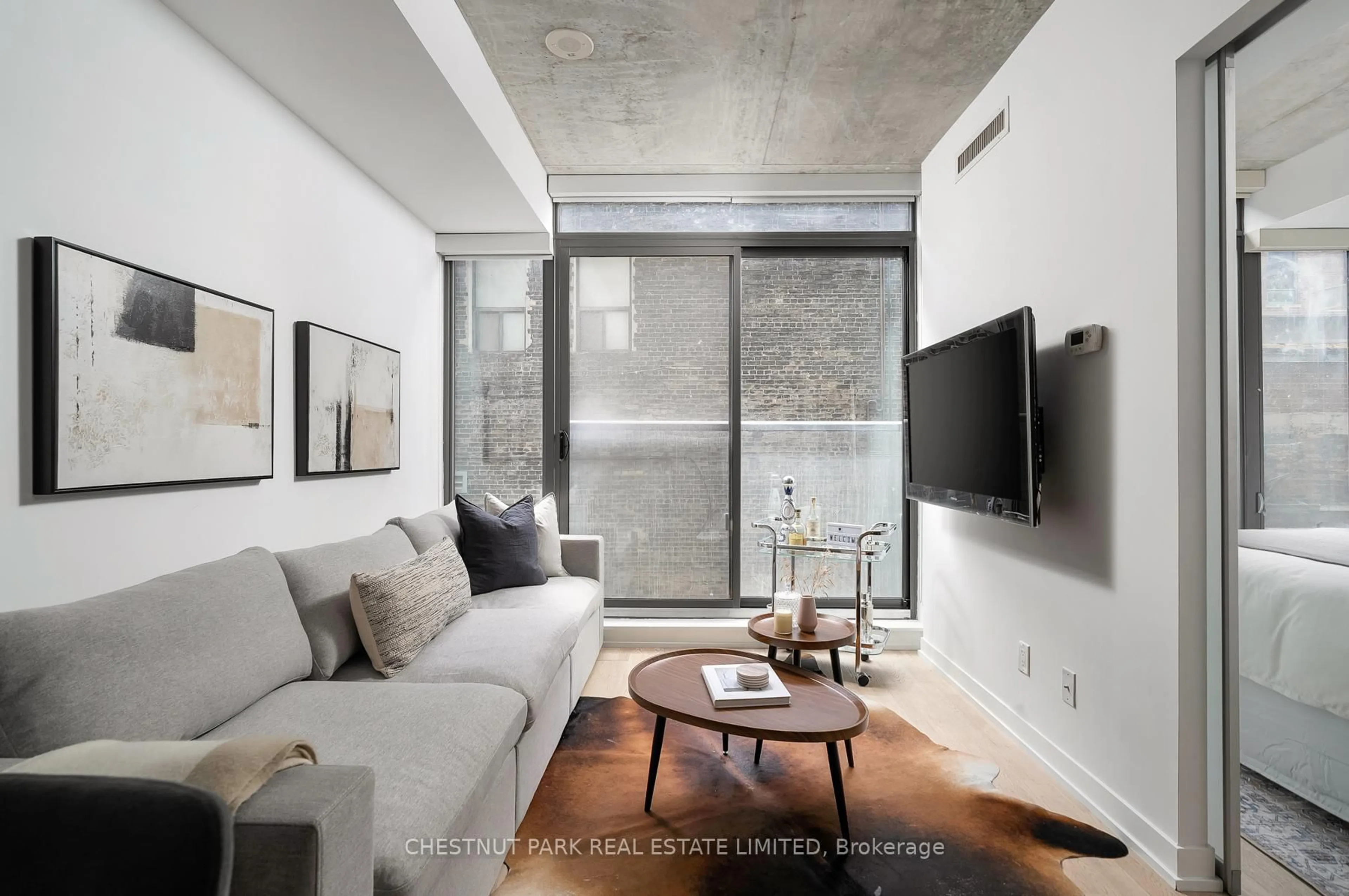 Living room with furniture, cement floor for 461 Adelaide St #230, Toronto Ontario M5V 0L6