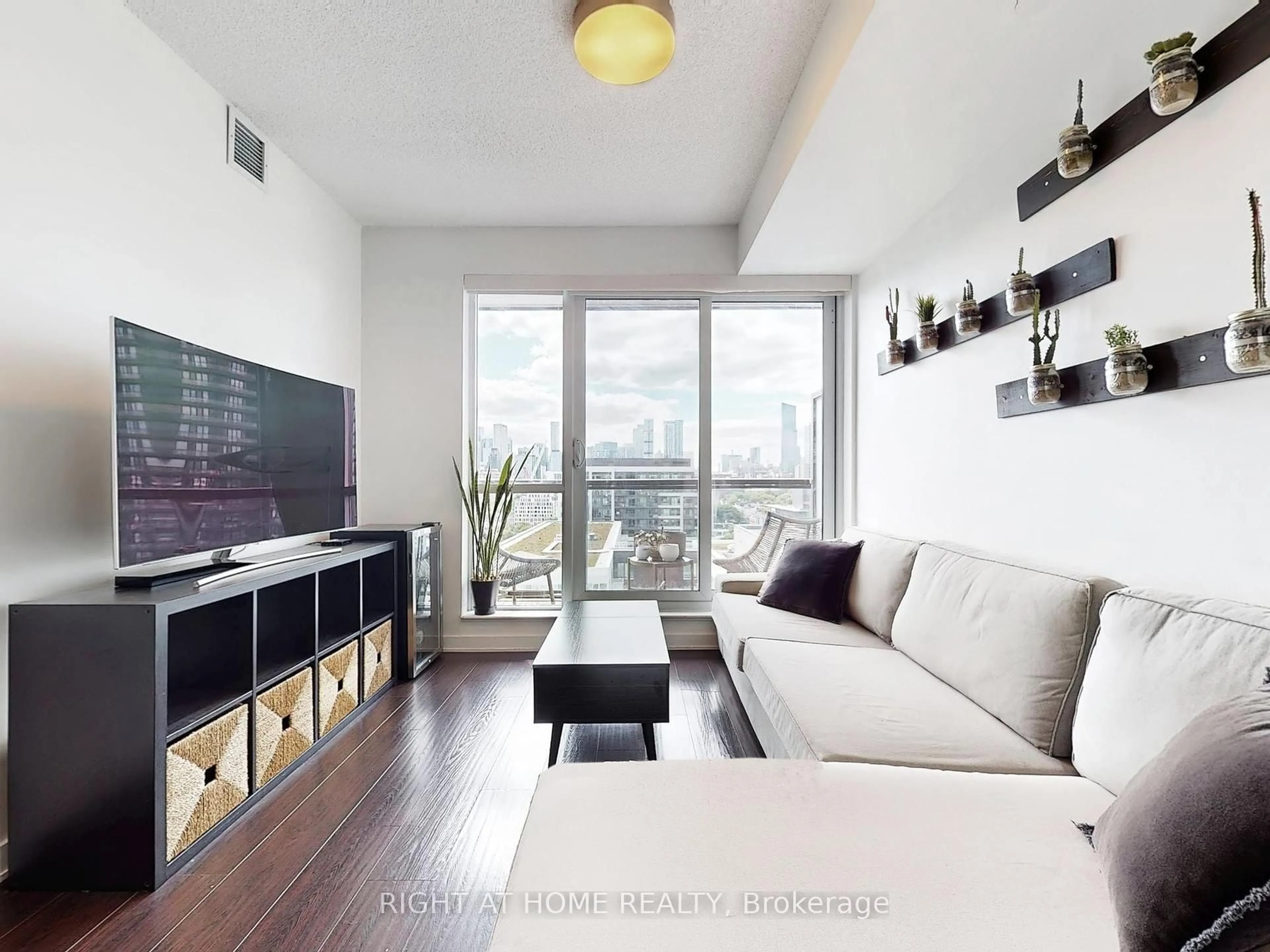 Living room with furniture, wood/laminate floor for 55 Regent Park Blvd #1407, Toronto Ontario M5A 0C2