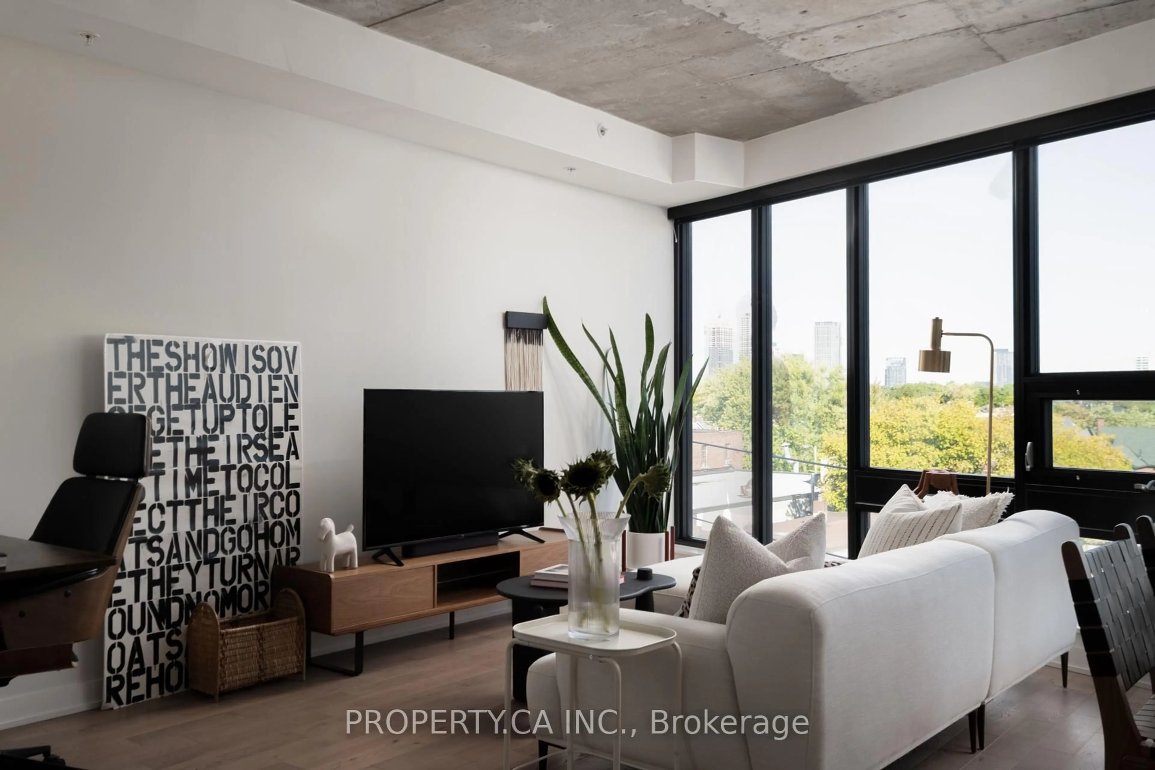 Living room with furniture, cement floor for 1239 Dundas St #507, Toronto Ontario M6J 1X6