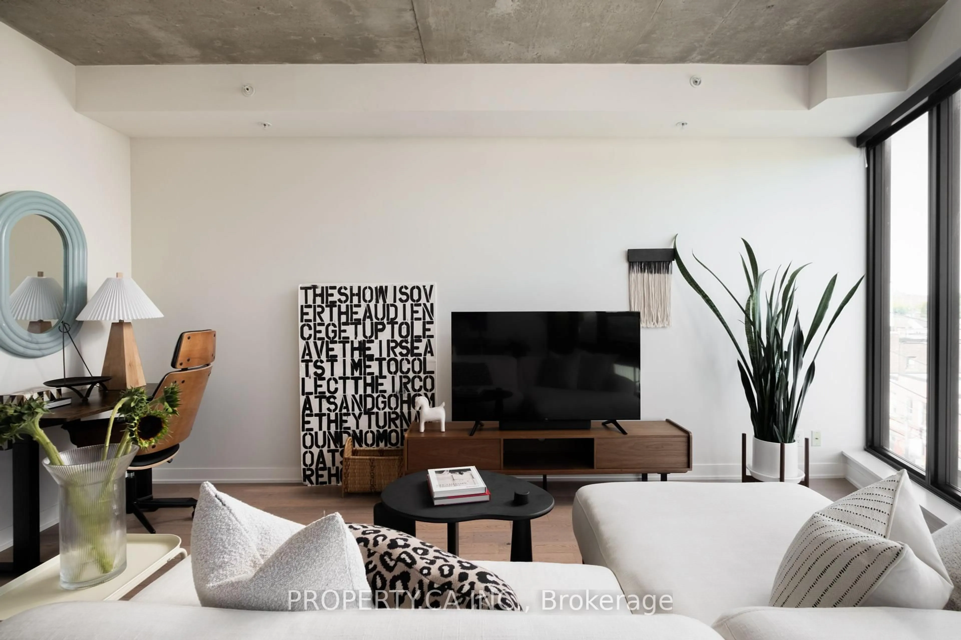 Living room with furniture, cement floor for 1239 Dundas St #507, Toronto Ontario M6J 1X6